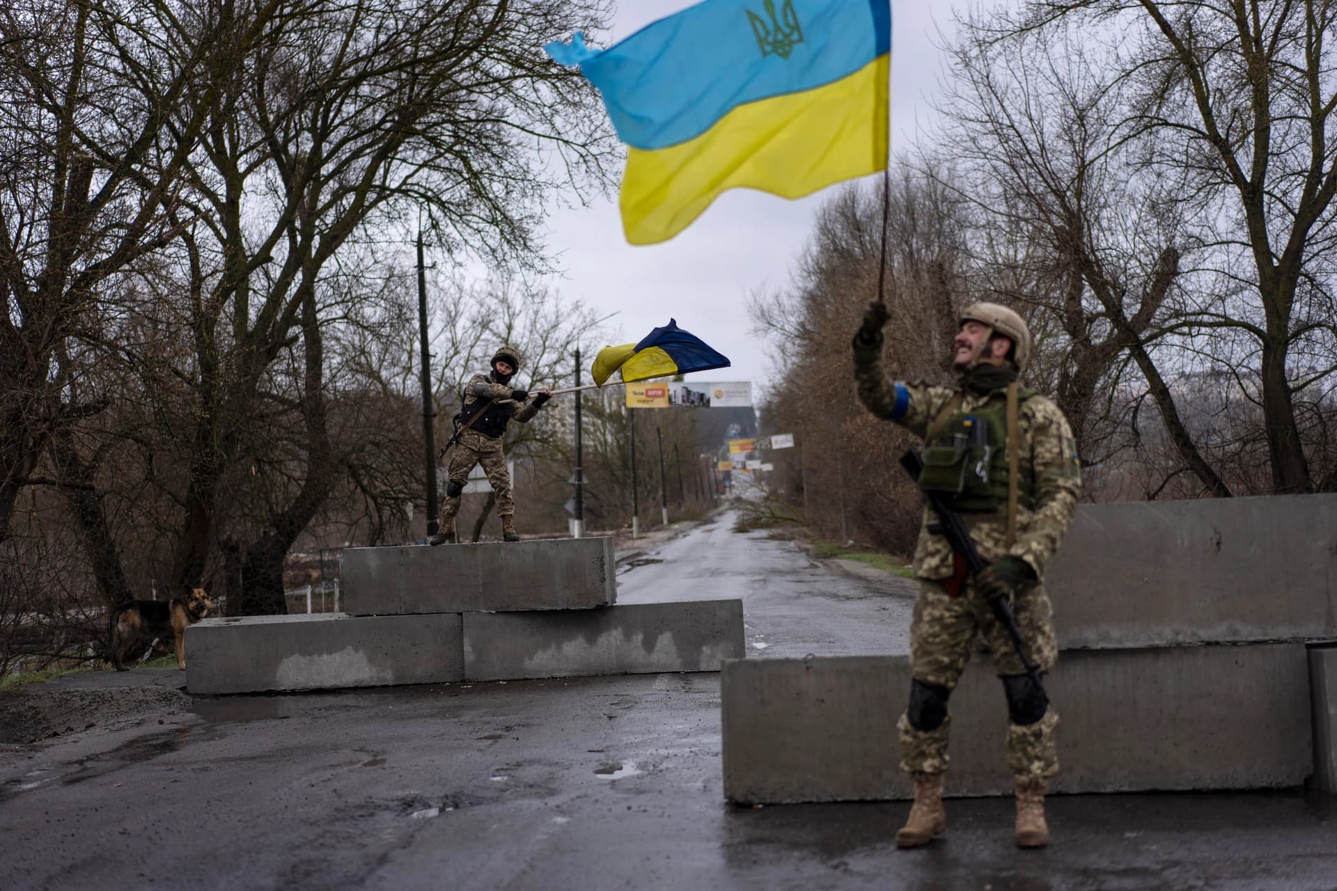 Ukrainian soldiers celebrate at a check point in Bucha, on the outskirts of Kyiv, Ukraine