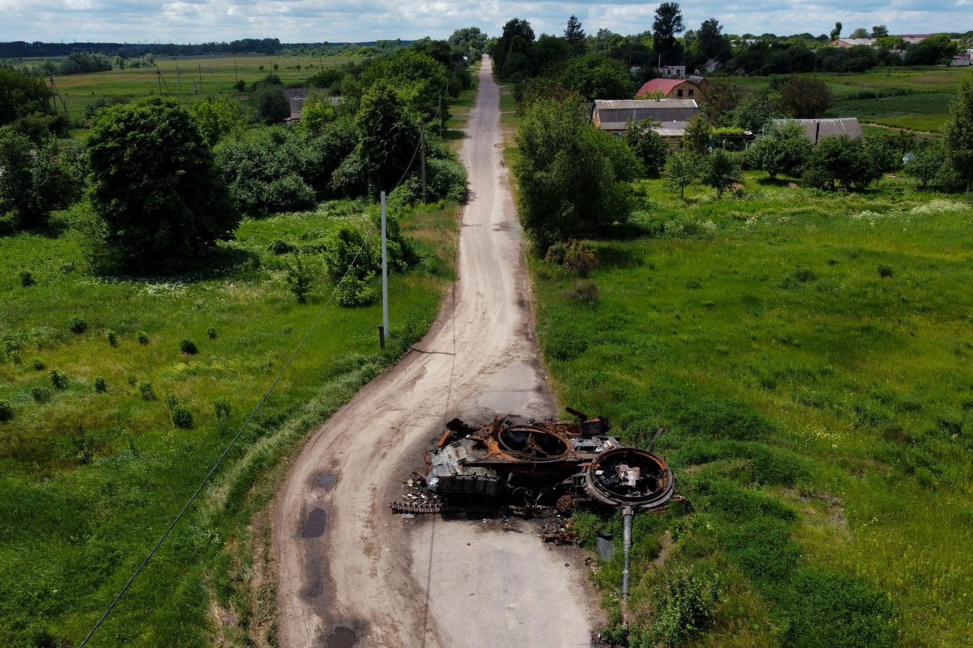 A ruined tank on a road in Lypivka, on the outskirts of Kyiv