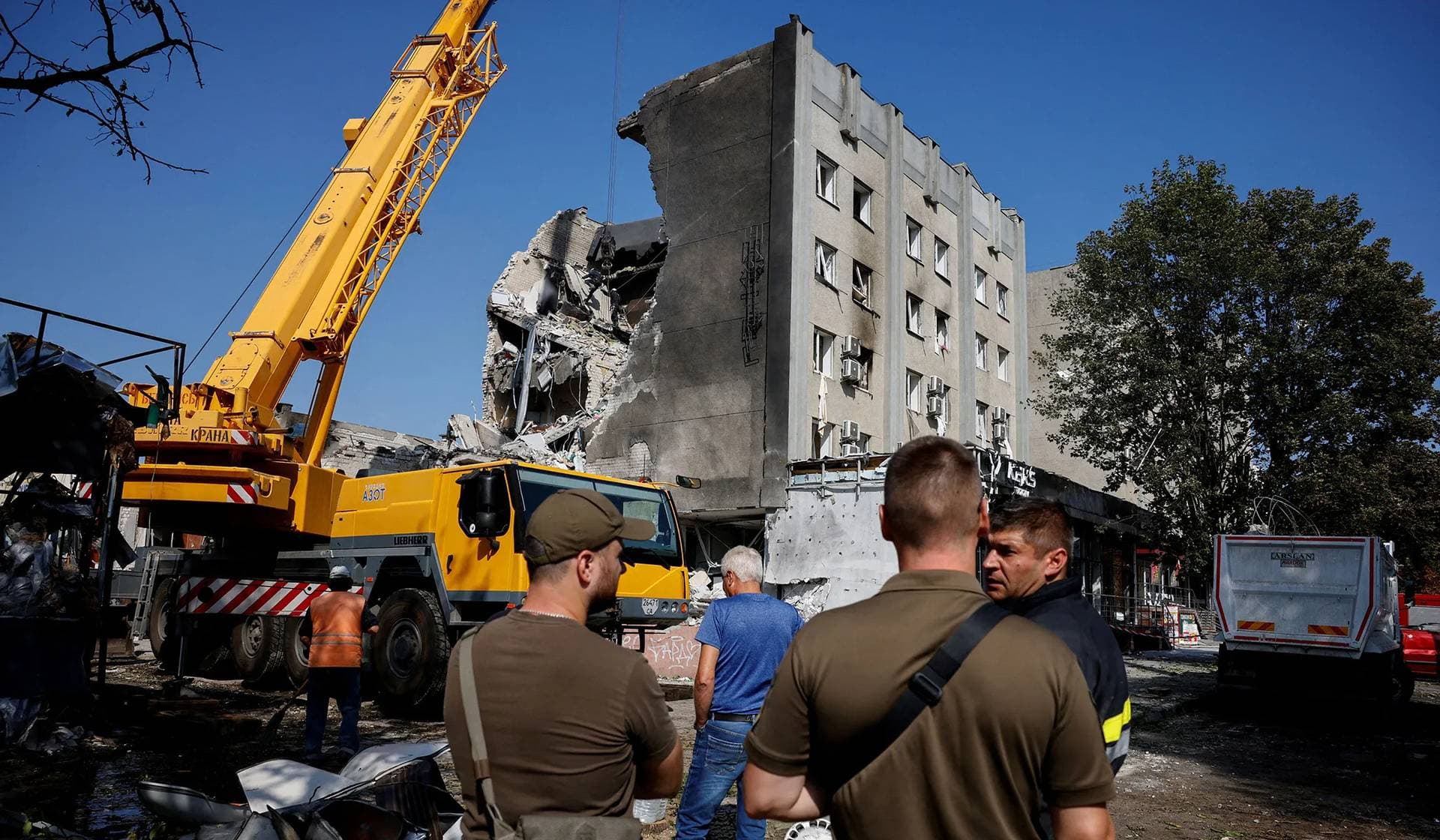 Emergency workers operate at the site of a heavily-damaged hotel during a Russian missile strike in Cherkasy