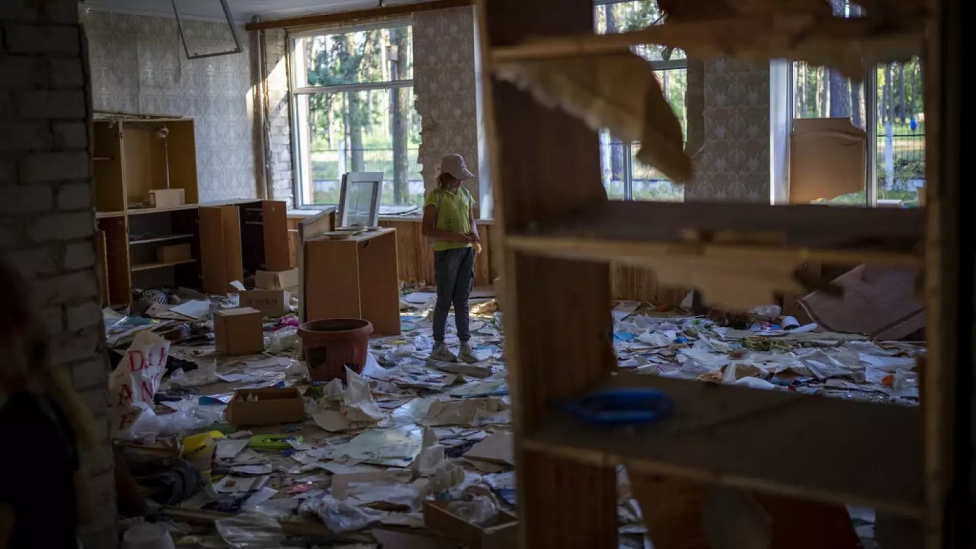 Surrounded by shards of broken glass and rubble 10-year-old Karina Muzyka, stands in the remains of her classroom in the Chernihiv School #21