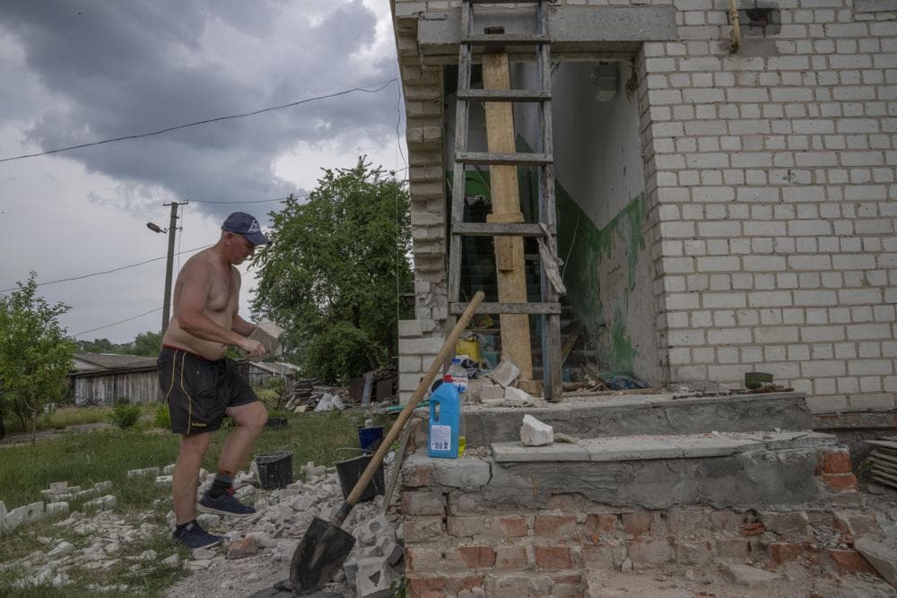 A man rebuilds his home after being destroyed by Russian strikes, Yahidne village, northern Chernihiv region