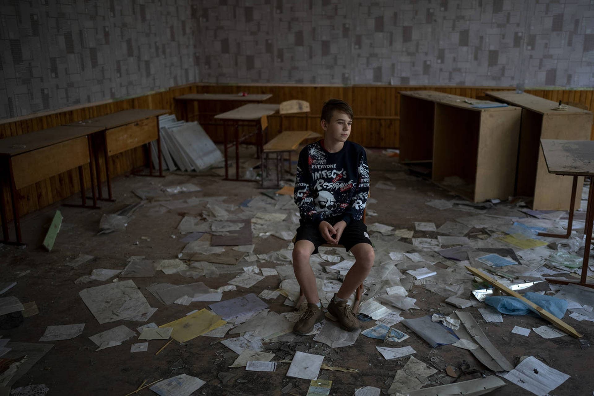 Oleksandr Morhunov sits in his chair in the remains of his classroom in the Chernihiv School #21