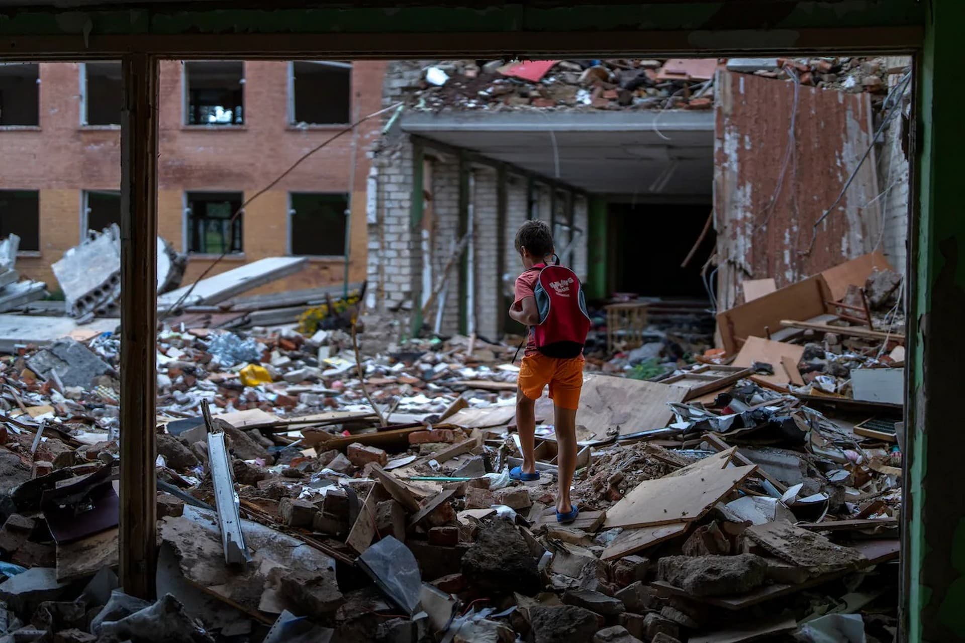 Ivan Hubenko walks on the rubble of his former Chernihiv School #21