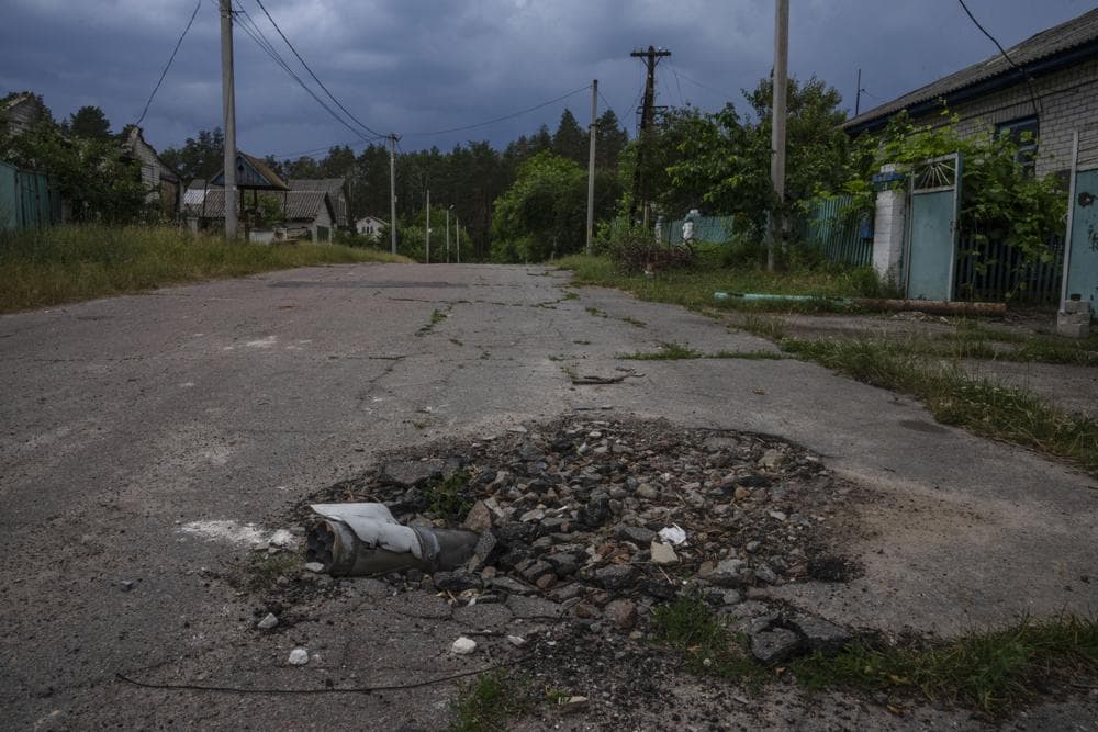 A part of a mortar shell lays on a road in Yahidne village, as civilians rebuild their homes after being destroyed by Russian strikes, northern Chernihiv region