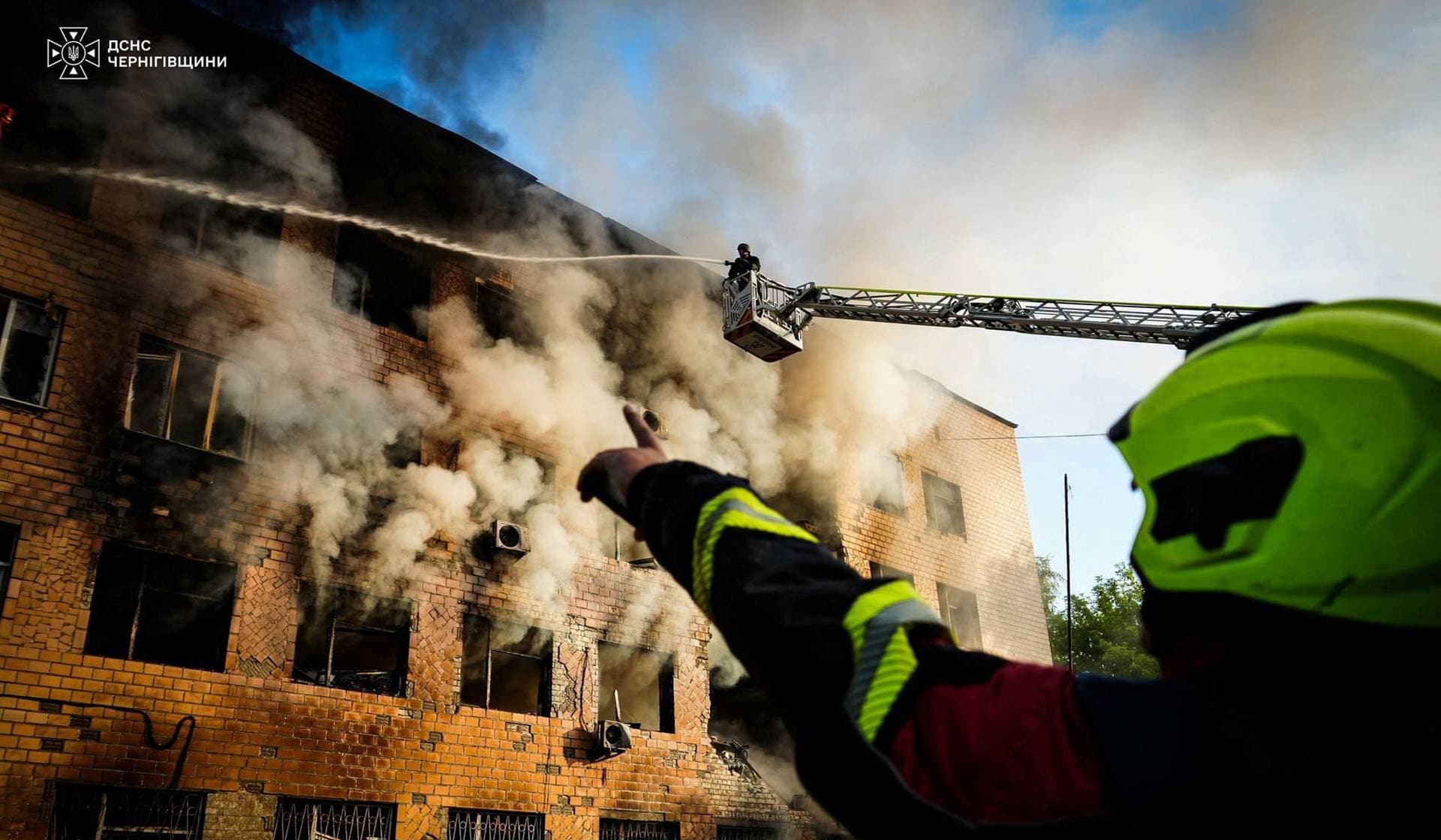 Firefighters work at the site of a administrative building which was damaged during a Russian drone strike in Chernihiv
