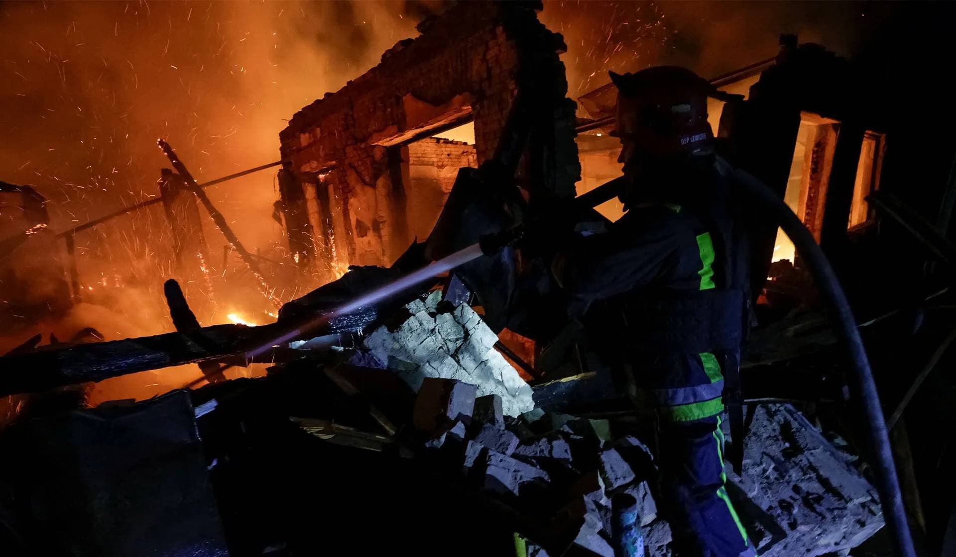 A firefighter works at the site of a Russian drone strike in Chuhuiv, Kharkiv region
