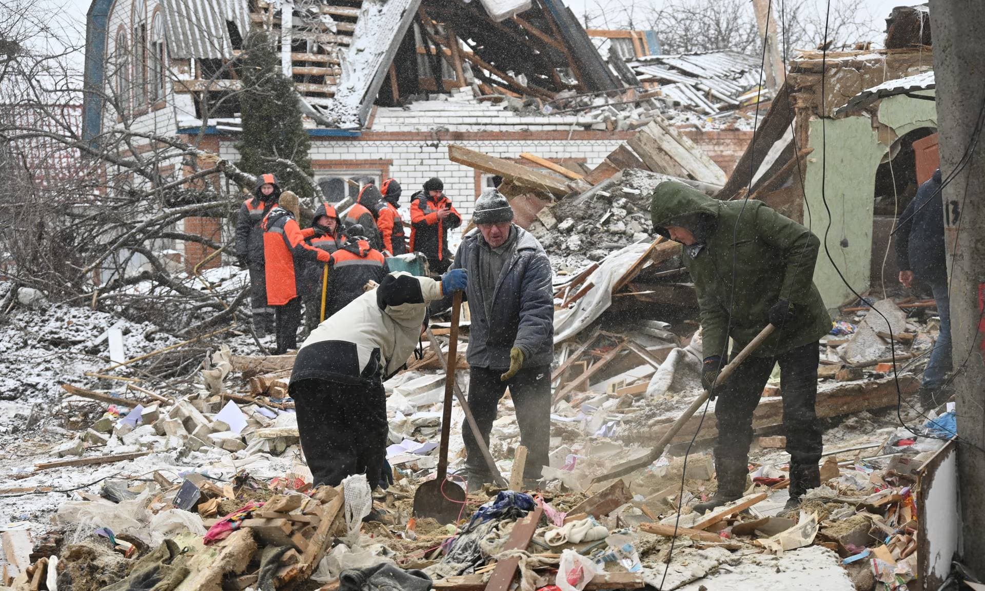 People clear debris after Russia bombed Zmiiv
