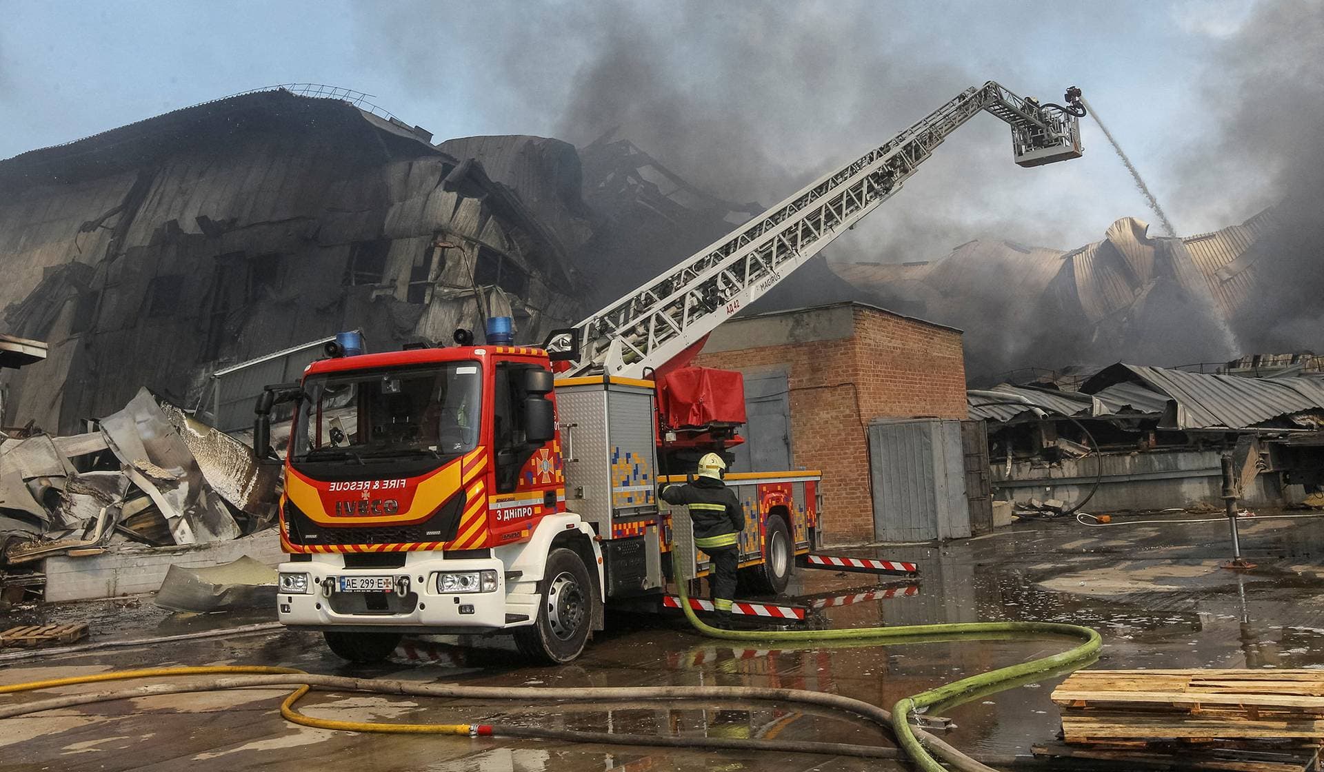 Firefighters work at a site of a Russian missile strike in Dnipro