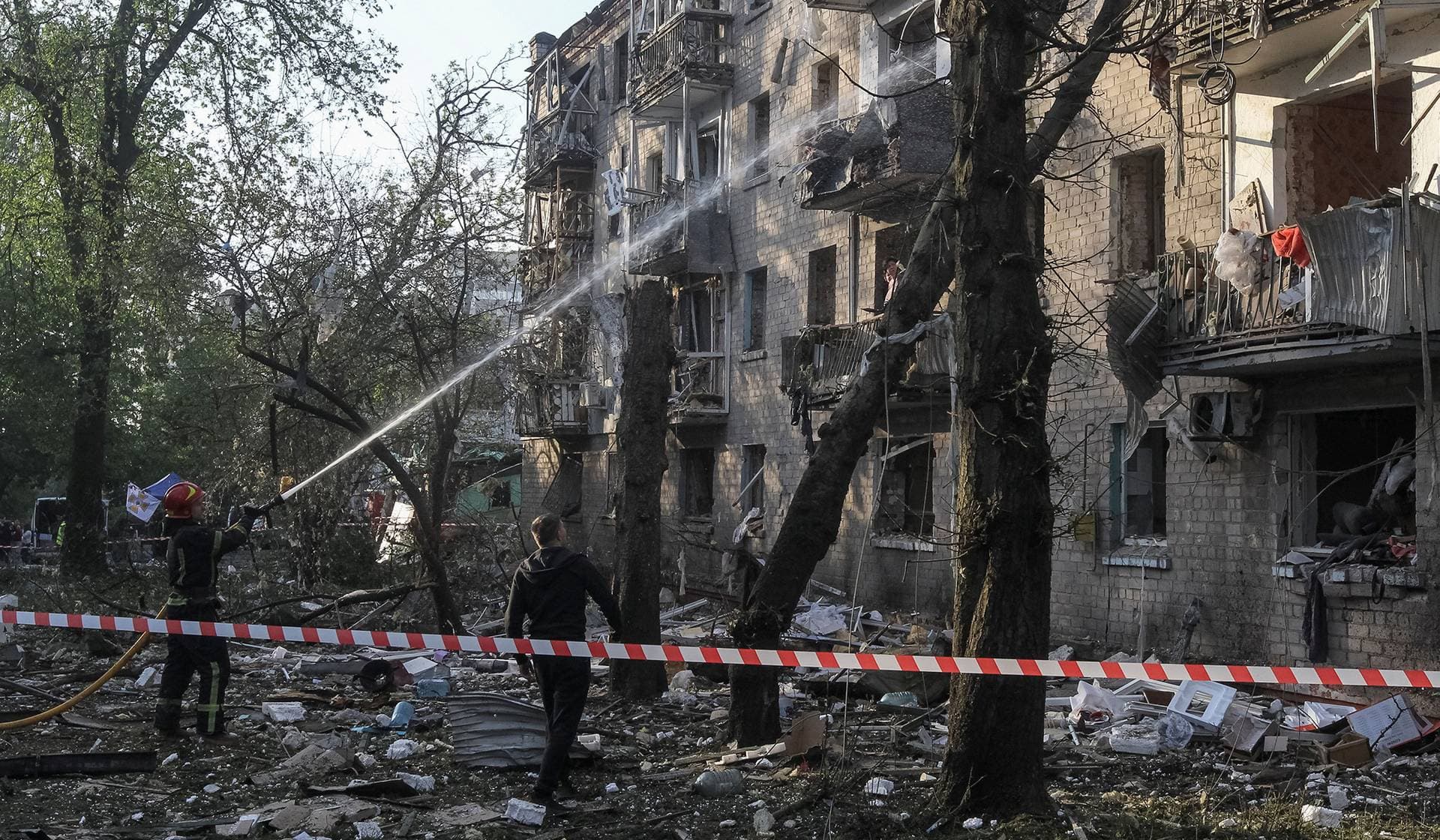 A firefighter works at a site of an apartment building damaged during a Russian missile strike in Dnipro
