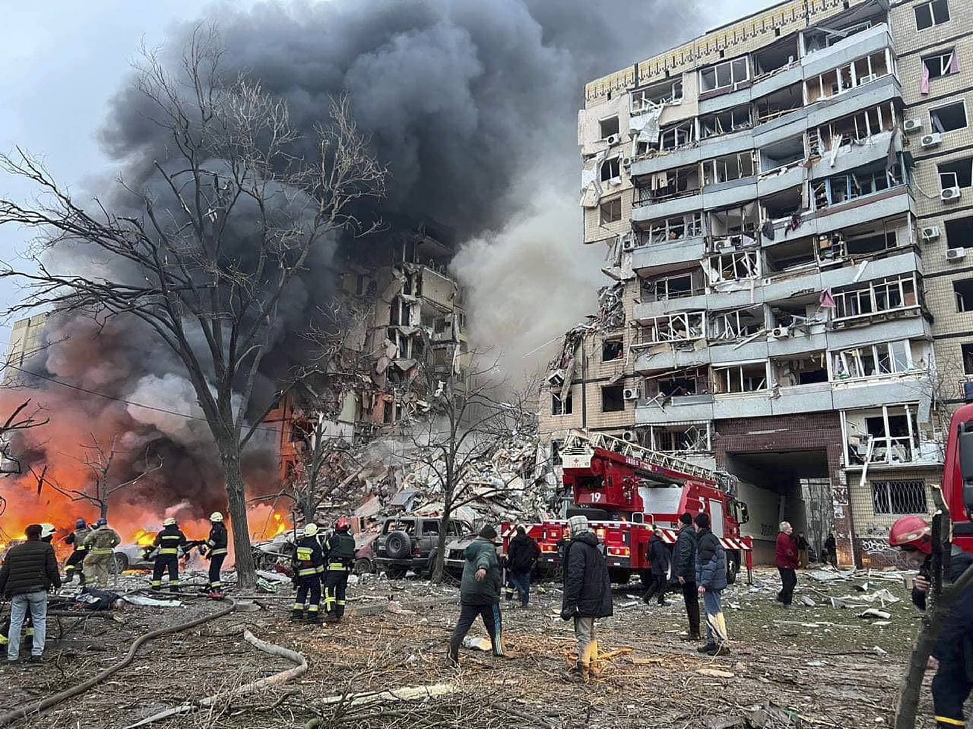 smoke rises after a Russian rocket hit a multistory building leaving many people under debris in Dnipro
