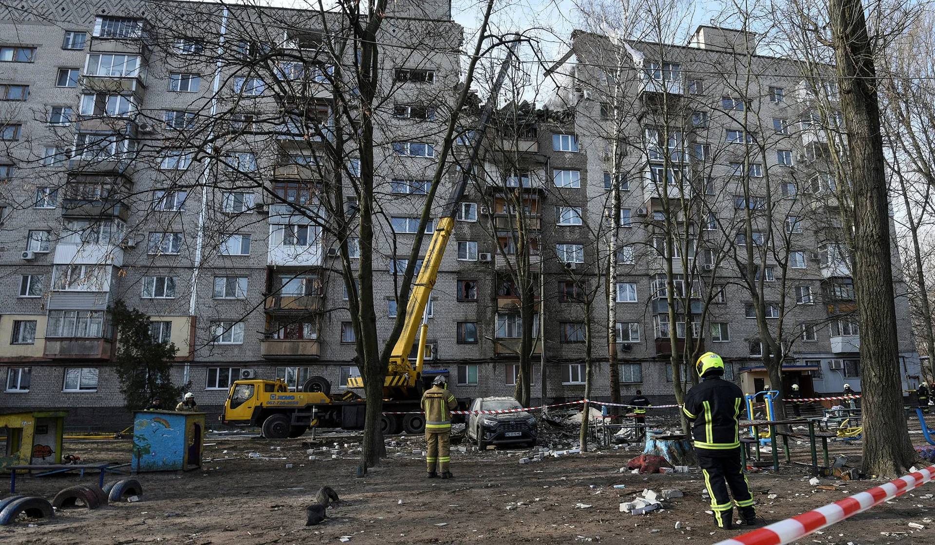 Rescue workers operate at the site of an apartment building damaged by a Russian drone strike in Dnipro