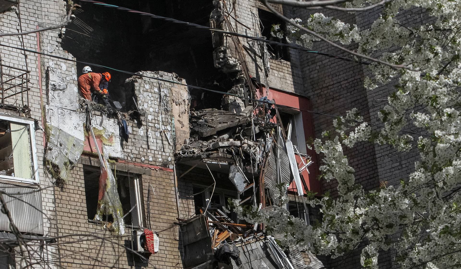 Rescuers work at the site of an apartment building hit by a Russian drone strike in Dnipro