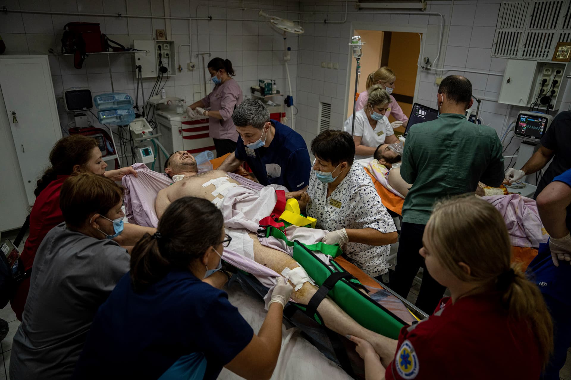 Medical staff move a seriously wounded Ukrainian serviceman at the ICU department of Mechnikov Hospital in Dnipro