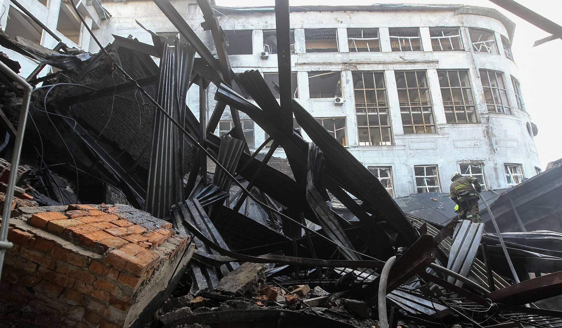 A rescuer works at the site of a university's building hit by a Russian drone strike in Dnipro