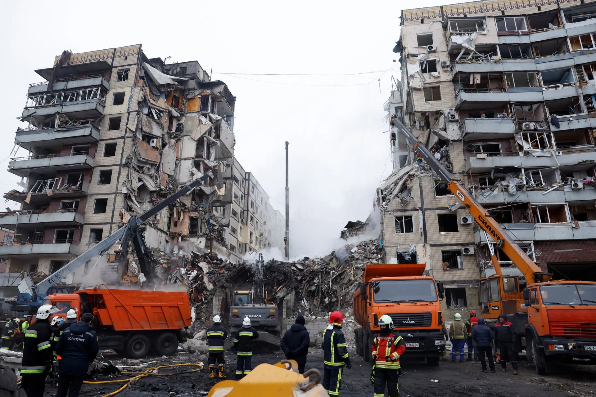 Emergency personnel work at the site where an apartment block was heavily damaged by a fatal Russian missile strike, in Dnipro