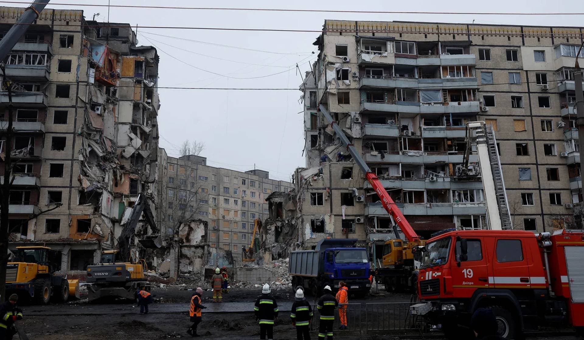 Emergency personnel work at the site where an apartment block was heavily damaged by a Russian missile strike in Dnipro