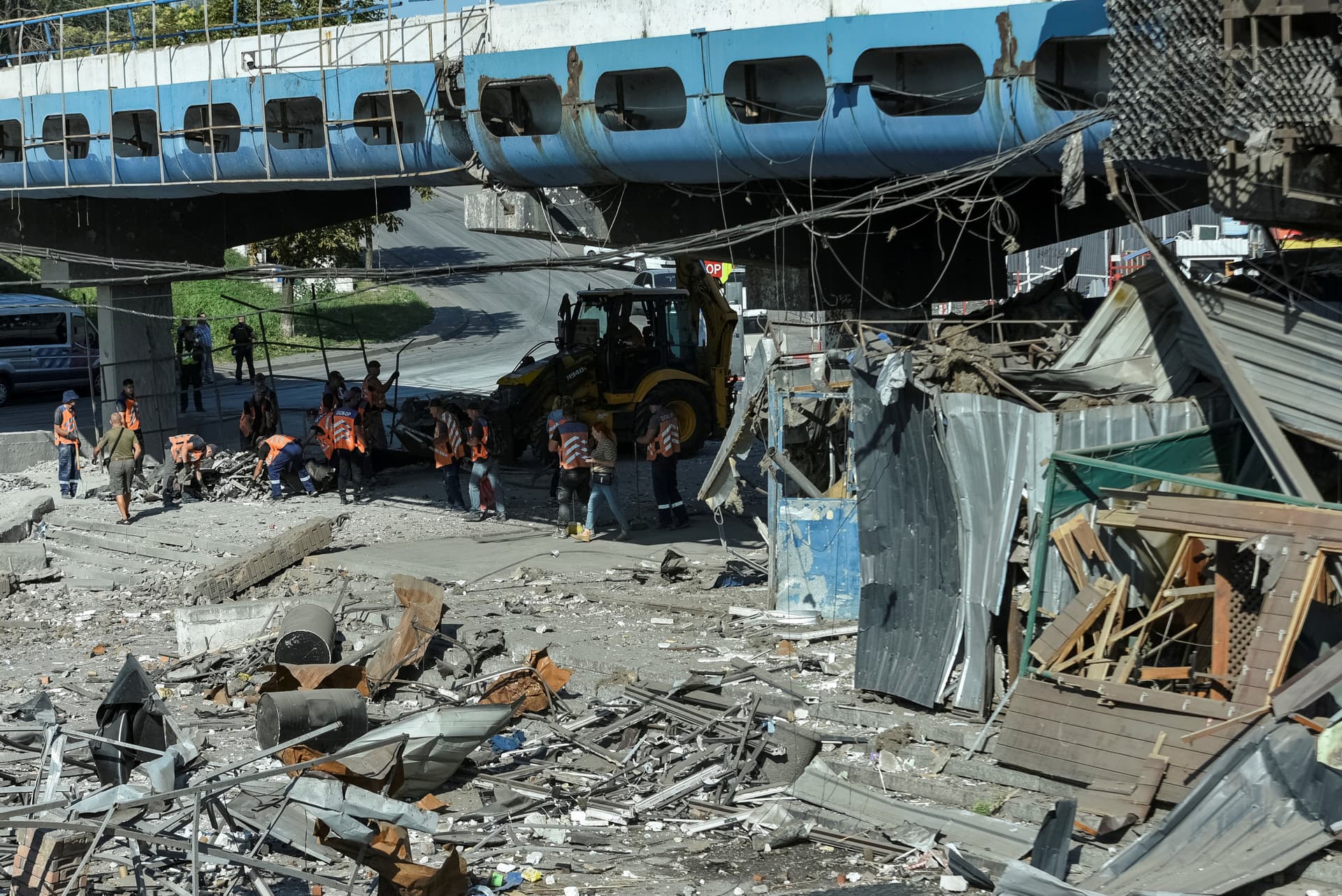 Communal workers clean at the site of a area destroyed during a Russian military strike in Dnipro