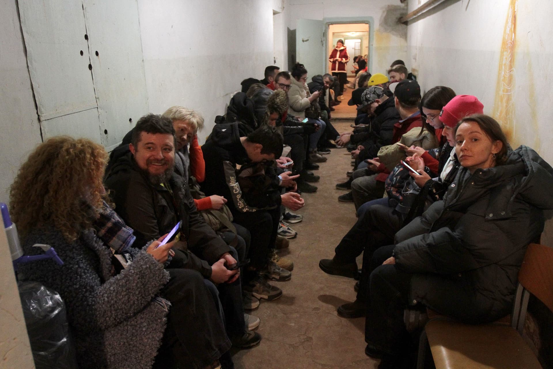 People take shelter after the first civil defence siren goes off in Dnipro, central Ukraine