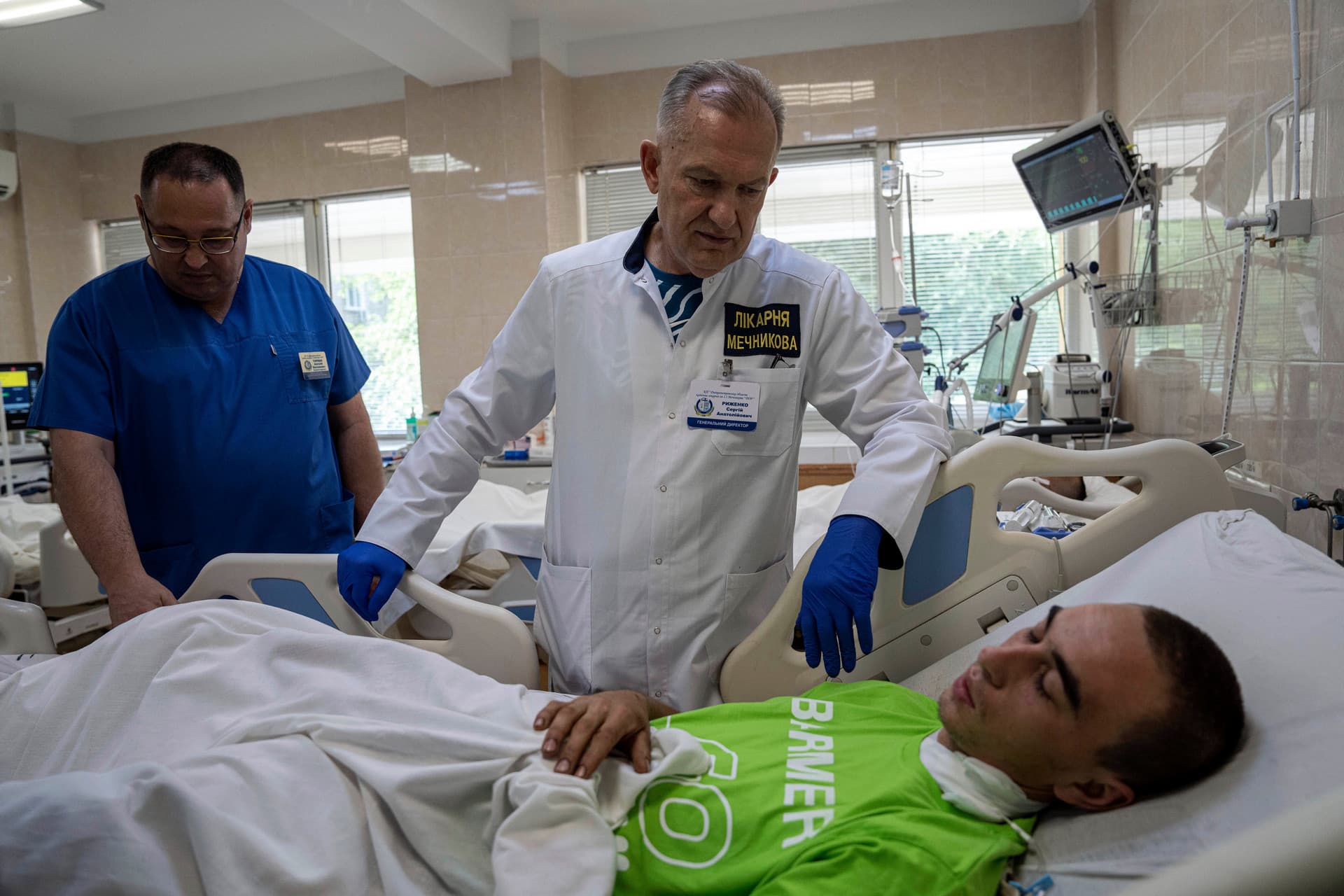 Chief Doctor speaks to an Ukrainian soldier, injured by a Russian tank near Lyman, at Mechnikov Hospital in Dnipro