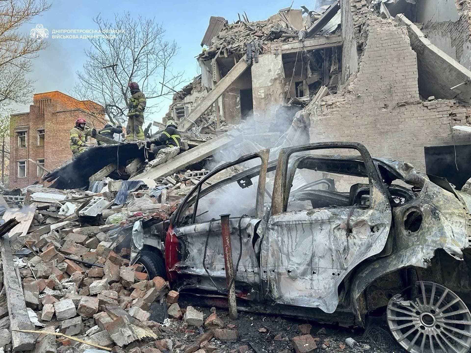 Rescuers work at the site of an apartment building hit by a Russian missile and drone strike in Dnipro