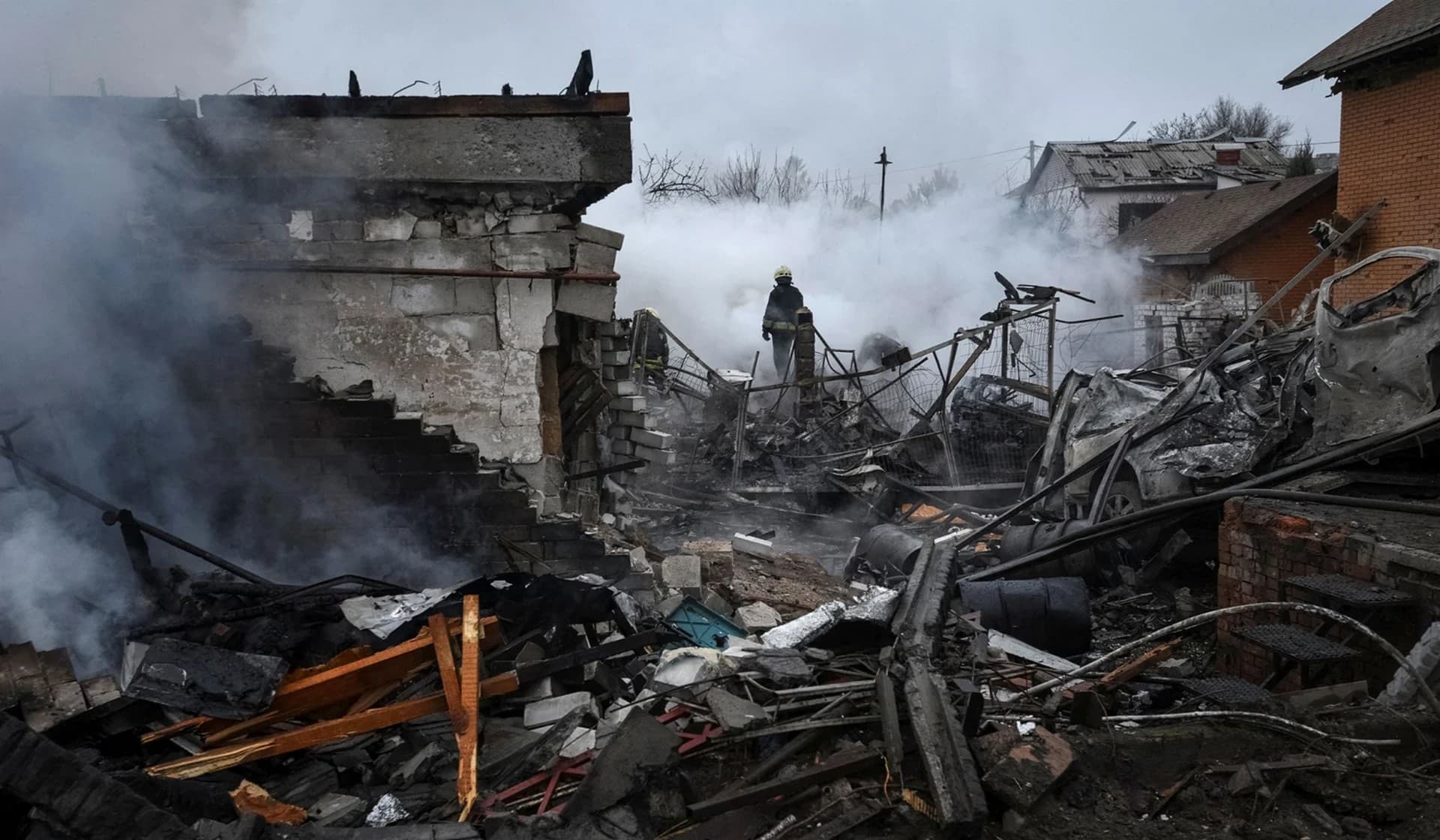 Rescuers work at a site of private houses heavily damaged by a Russian missile strike in Dnipro