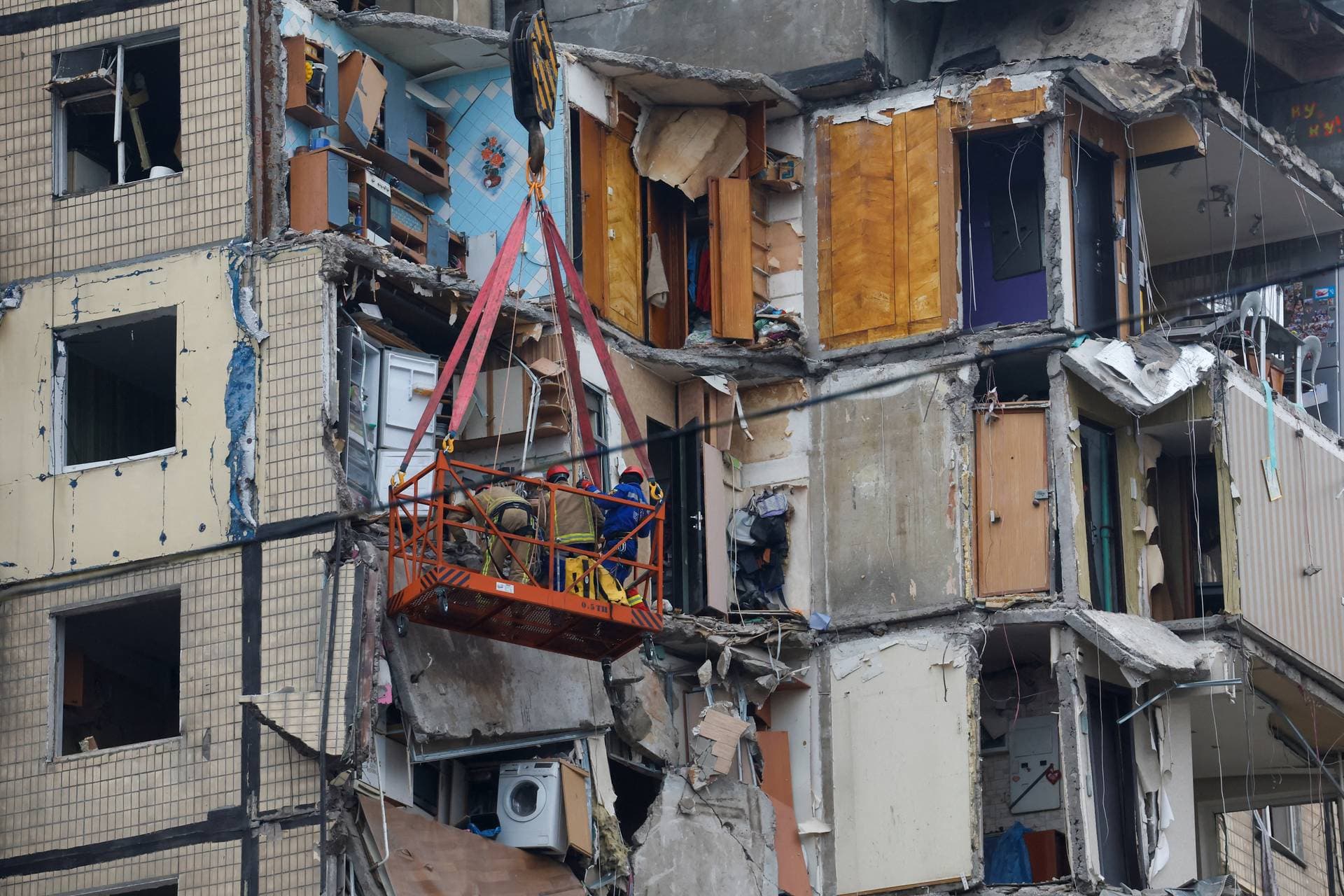 Emergency personnel work at a site in Dnipro, Ukraine, where an apartment block was heavily damaged by a Russian missile