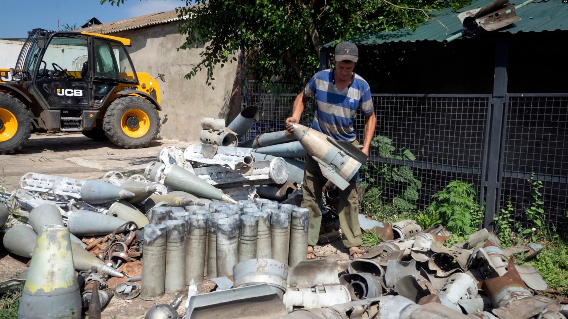 A farmer collects fragments of Russian rockets that landed in his field 10 kilometers from the front line in the Dnipropetrovsk region
