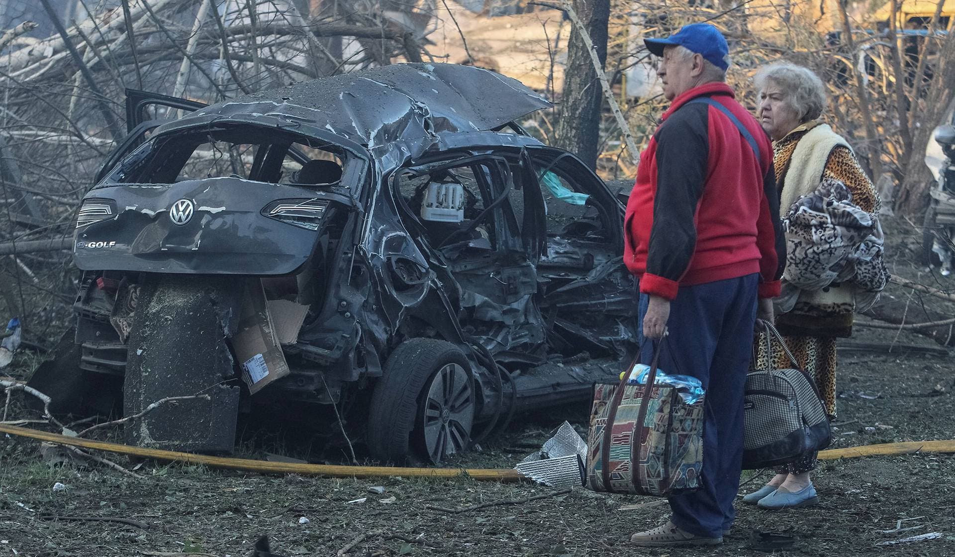 Residents stand at a site of a Russian drone and missile strike in Dnipro