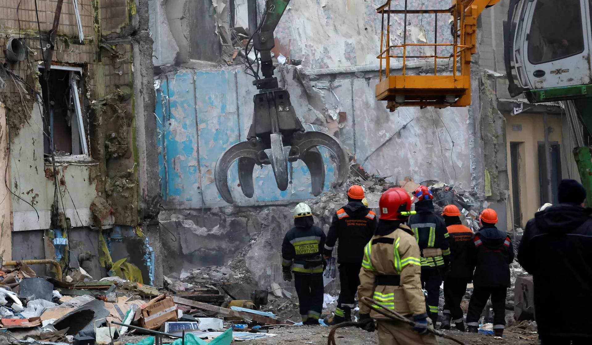 Emergency personnel work at the site where an apartment block was heavily damaged by a Russian missile strike in Dnipro