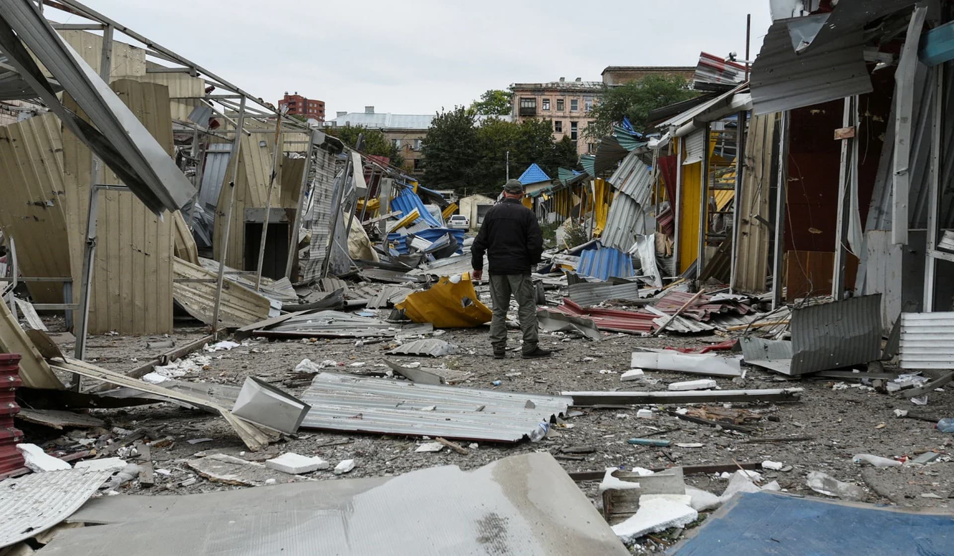 A man stands in a market destroyed by a Russian missile strike in central Dnipro