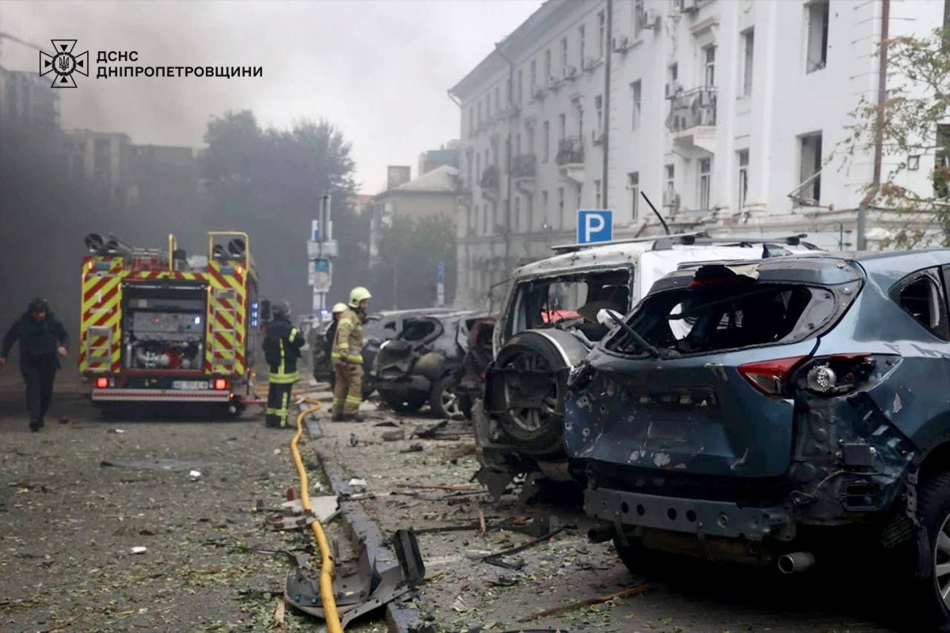 Rescuers work at the site of the Russian drone strike in Dnipro
