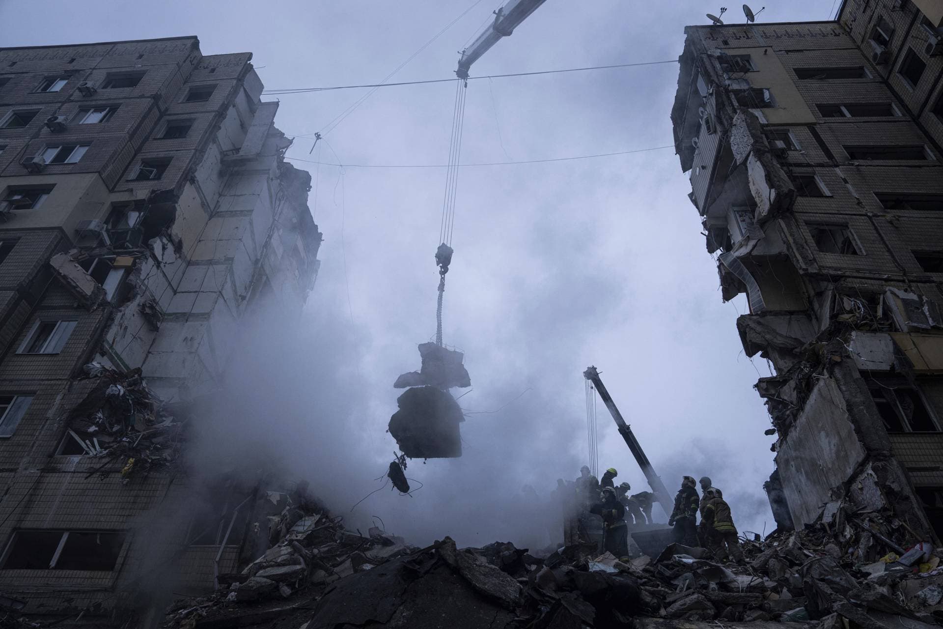 Rescue workers clear the rubble from an apartment building that was destroyed in a Russian rocket attack at a residential neighbourhood in the southeastern city of Dnipro