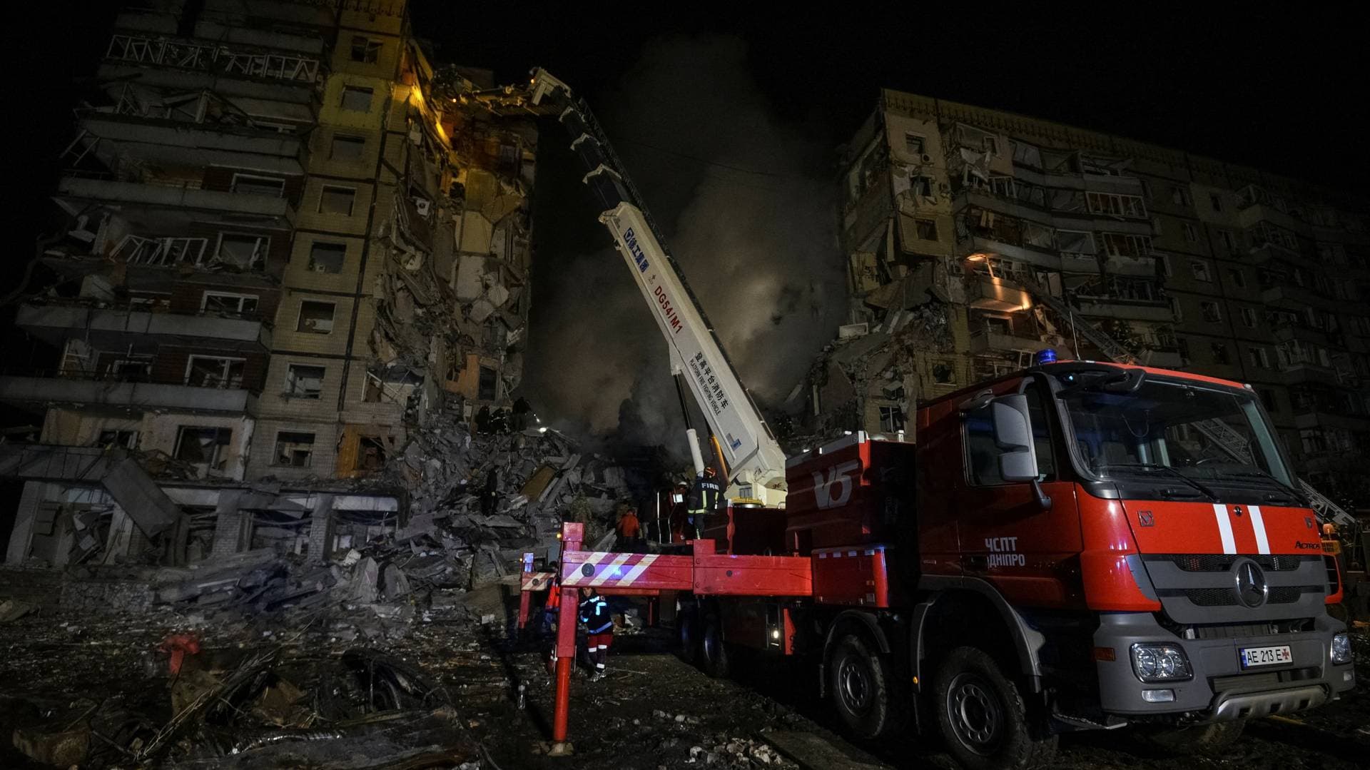 Rescuers work at the site where an apartment building was heavily damaged by a Russian missile strike in Dnipro