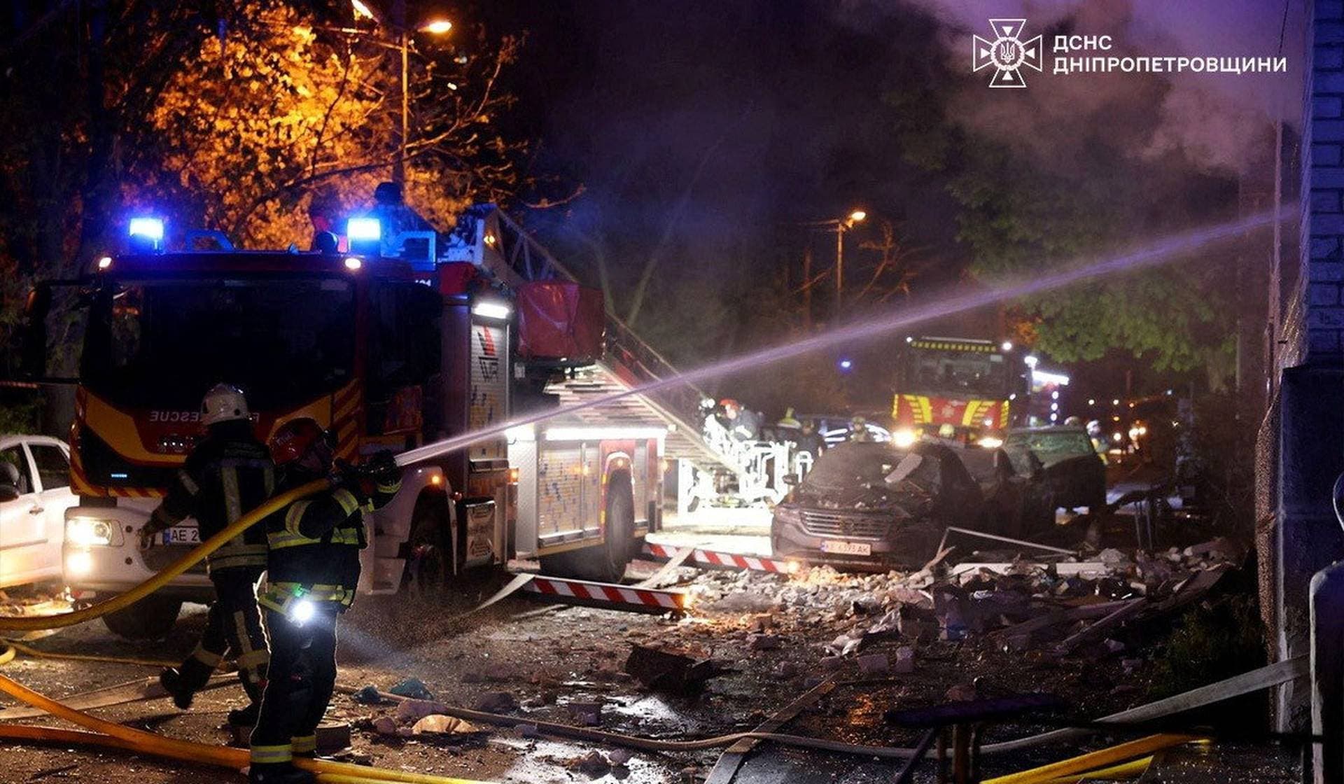 Rescuers work at the site of a Russian drone strike in Dnipro