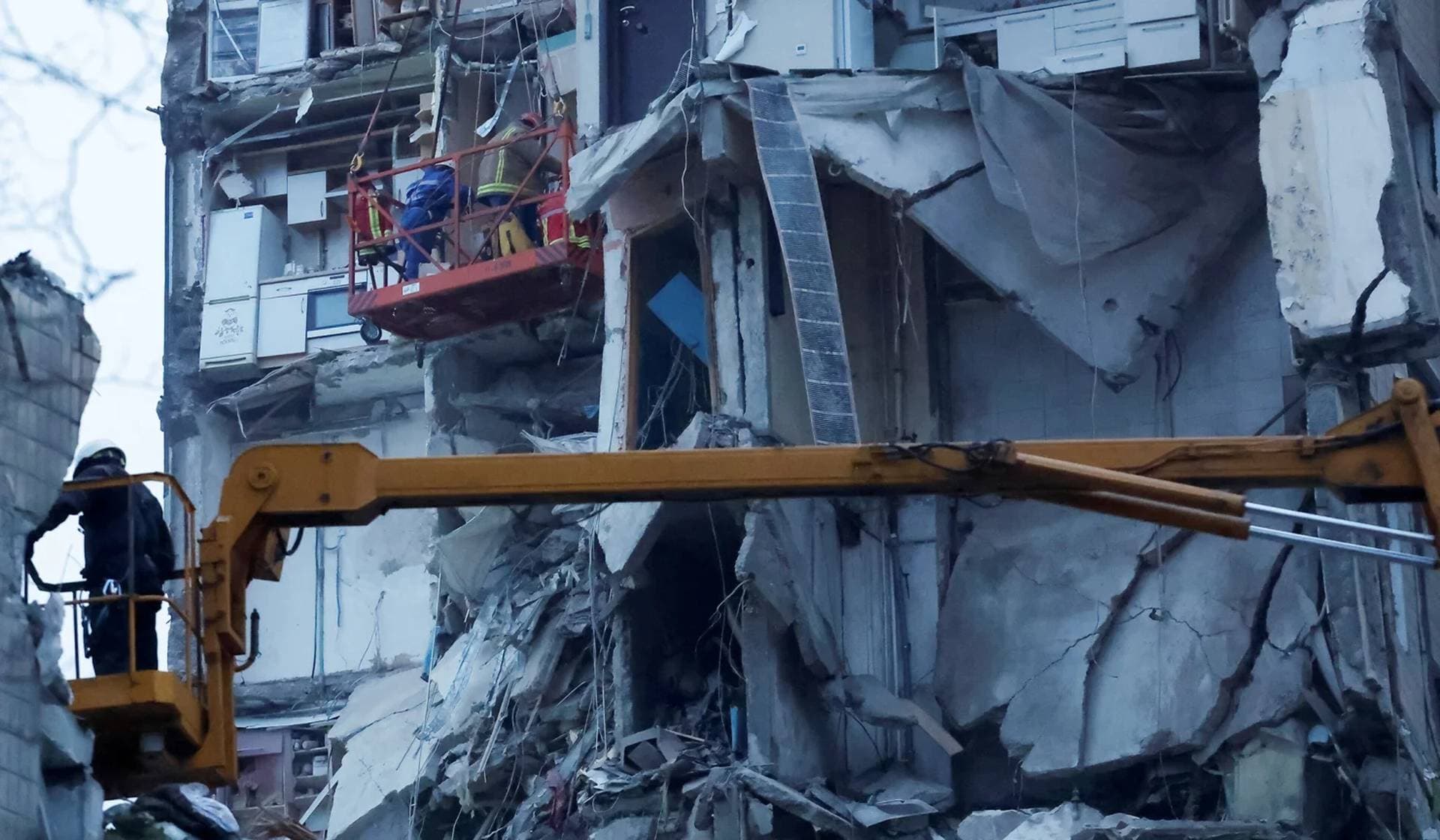 Emergency personnel work at the site where an apartment block was heavily damaged by a Russian missile strike in Dnipro