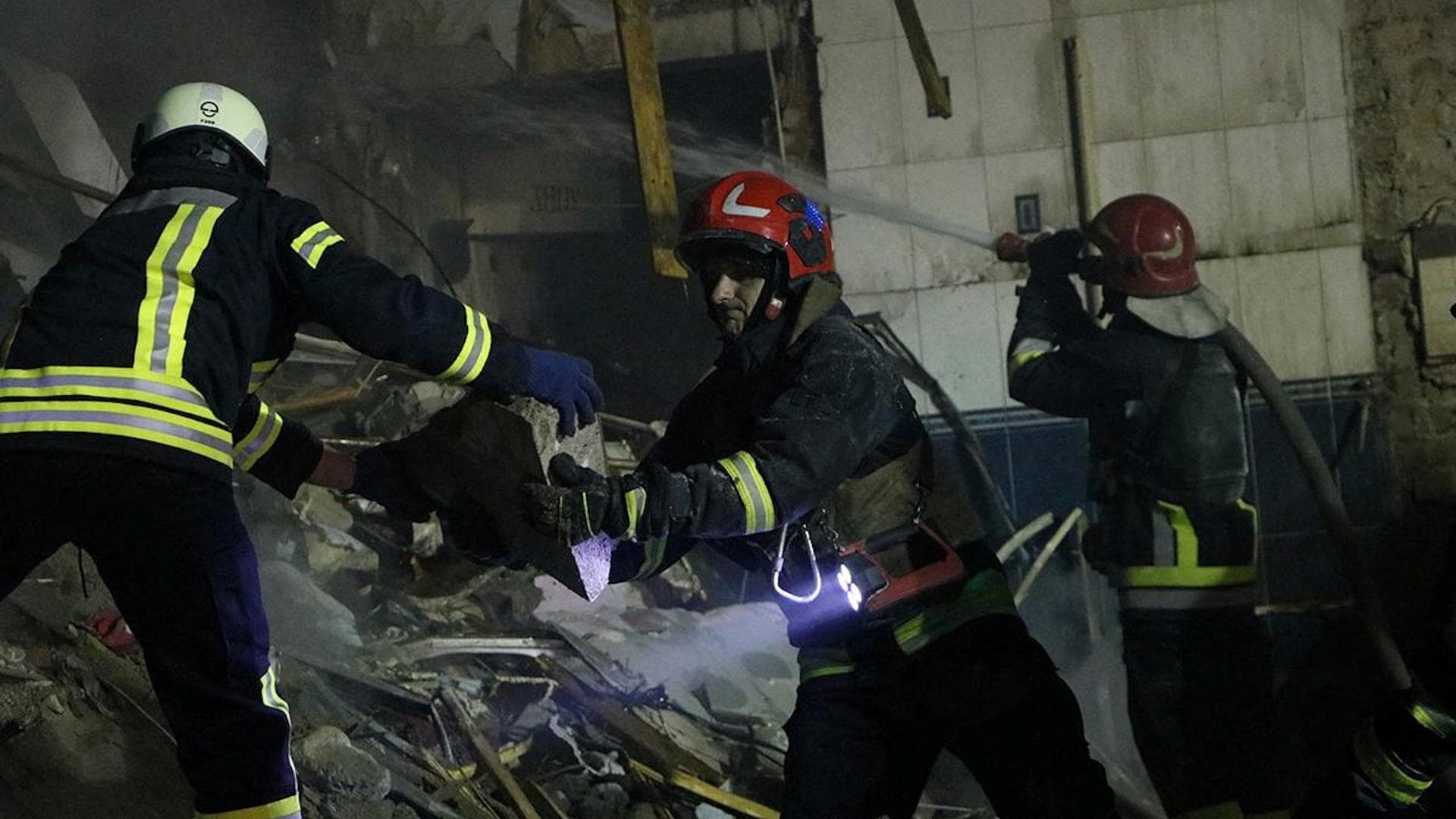 Rescuers work at a site of a residential building heavily damaged by a Russian missile strike on the outskirts of Dnipro