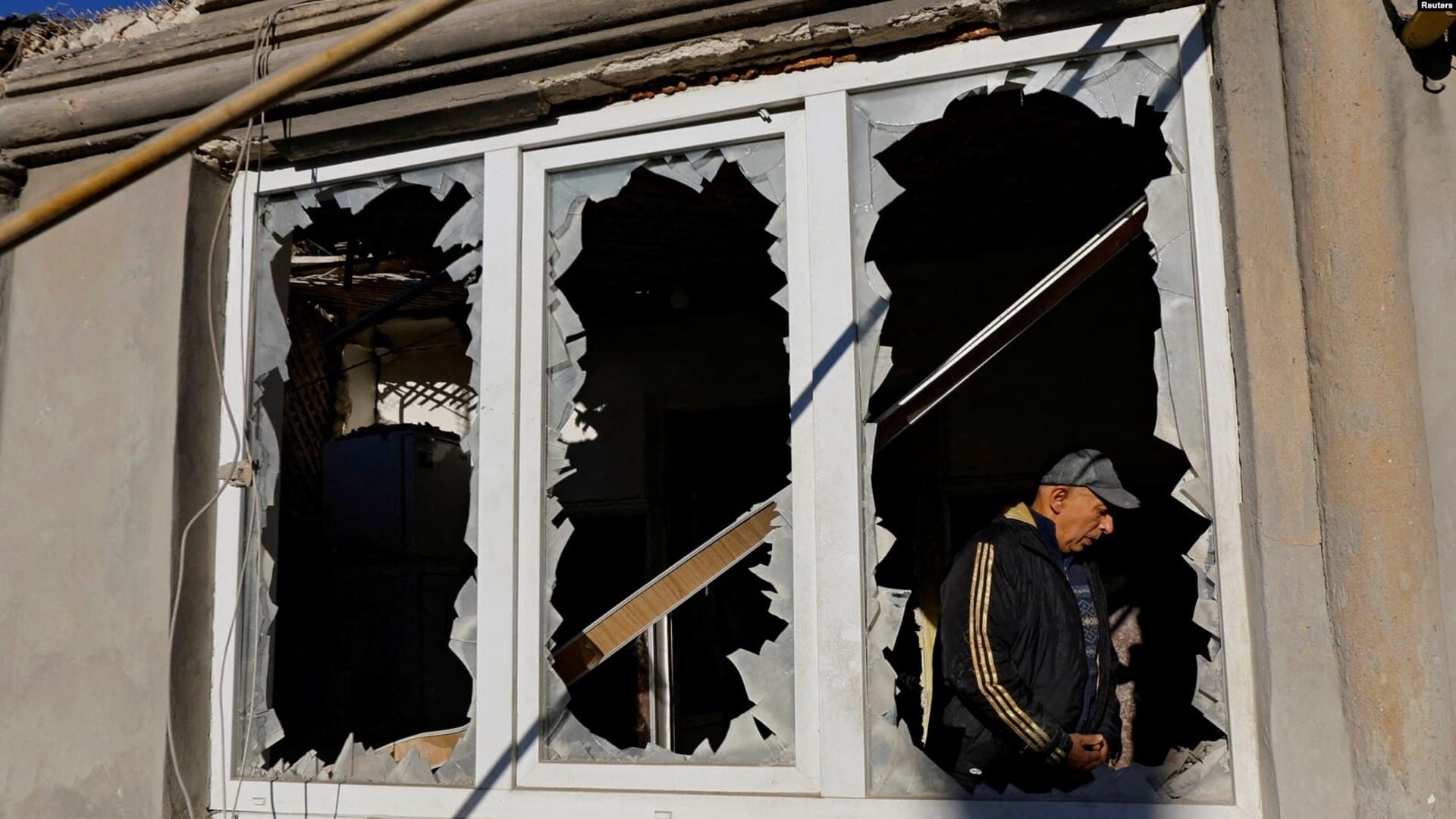 A man stands inside his house, damaged by recent shelling in Donetsk