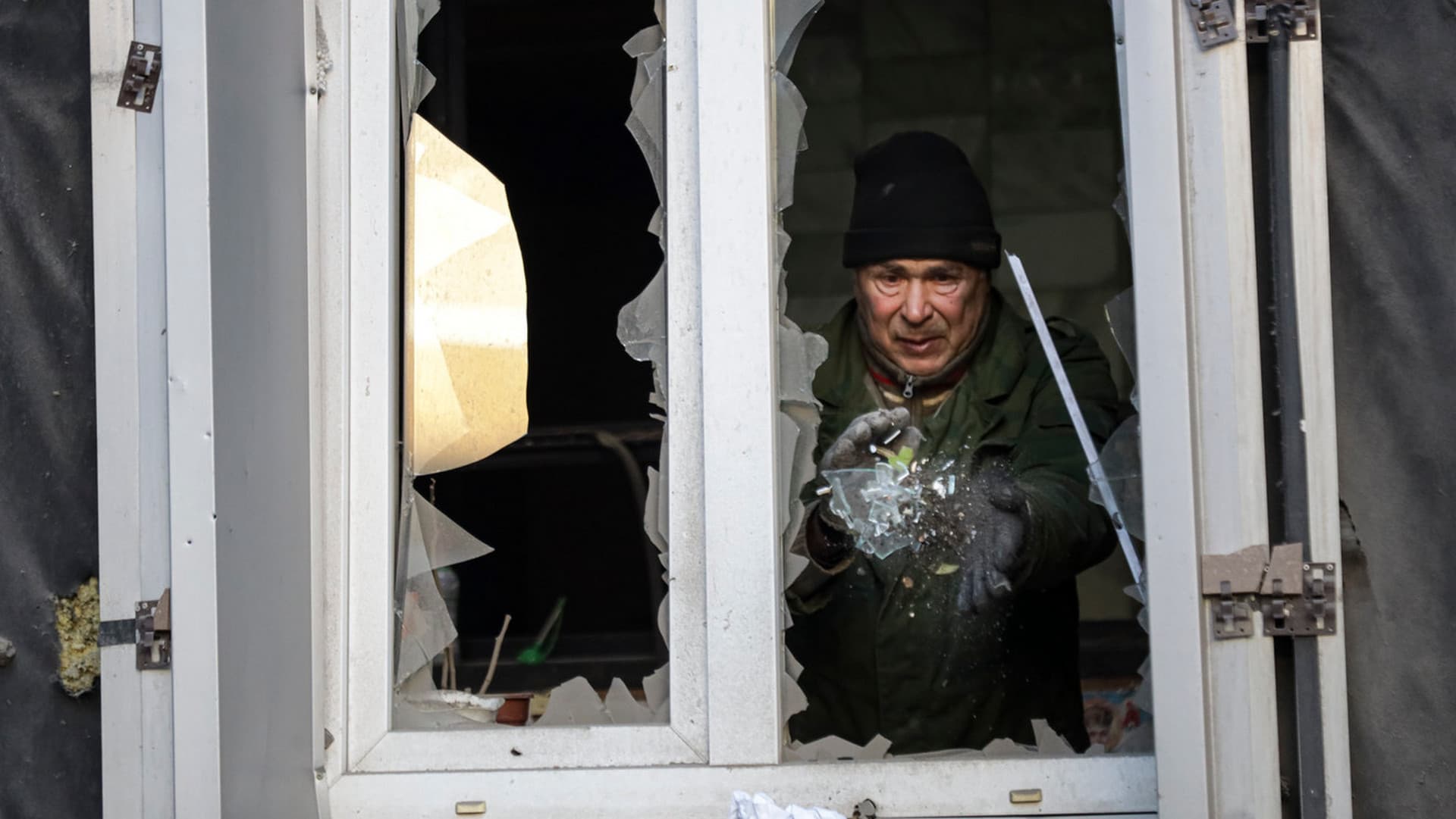 An employee cleans broken glass a damaged part of the hospital of Donetsk Clinical Territorial Medical Association is seen after a shelling, in Donetsk
