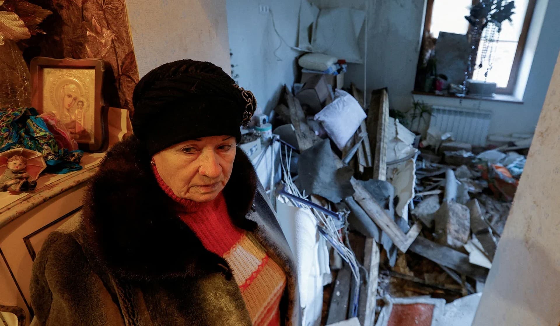 Local resident Lyudmila, 70, shows her apartment inside a house heavily damaged in recent shelling in Donetsk