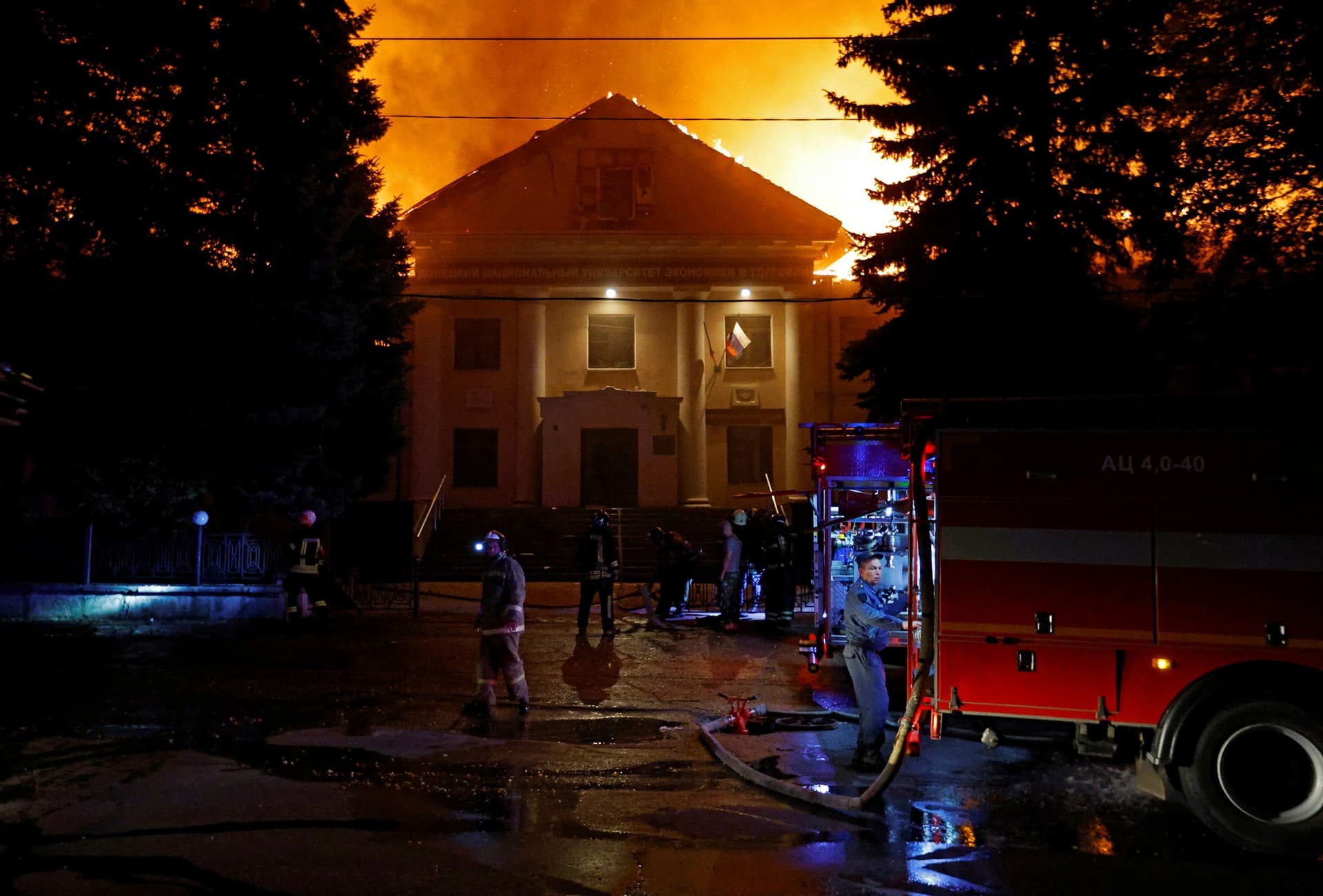 Firefighters extinguish a fire in the university building following an attack in Donetsk