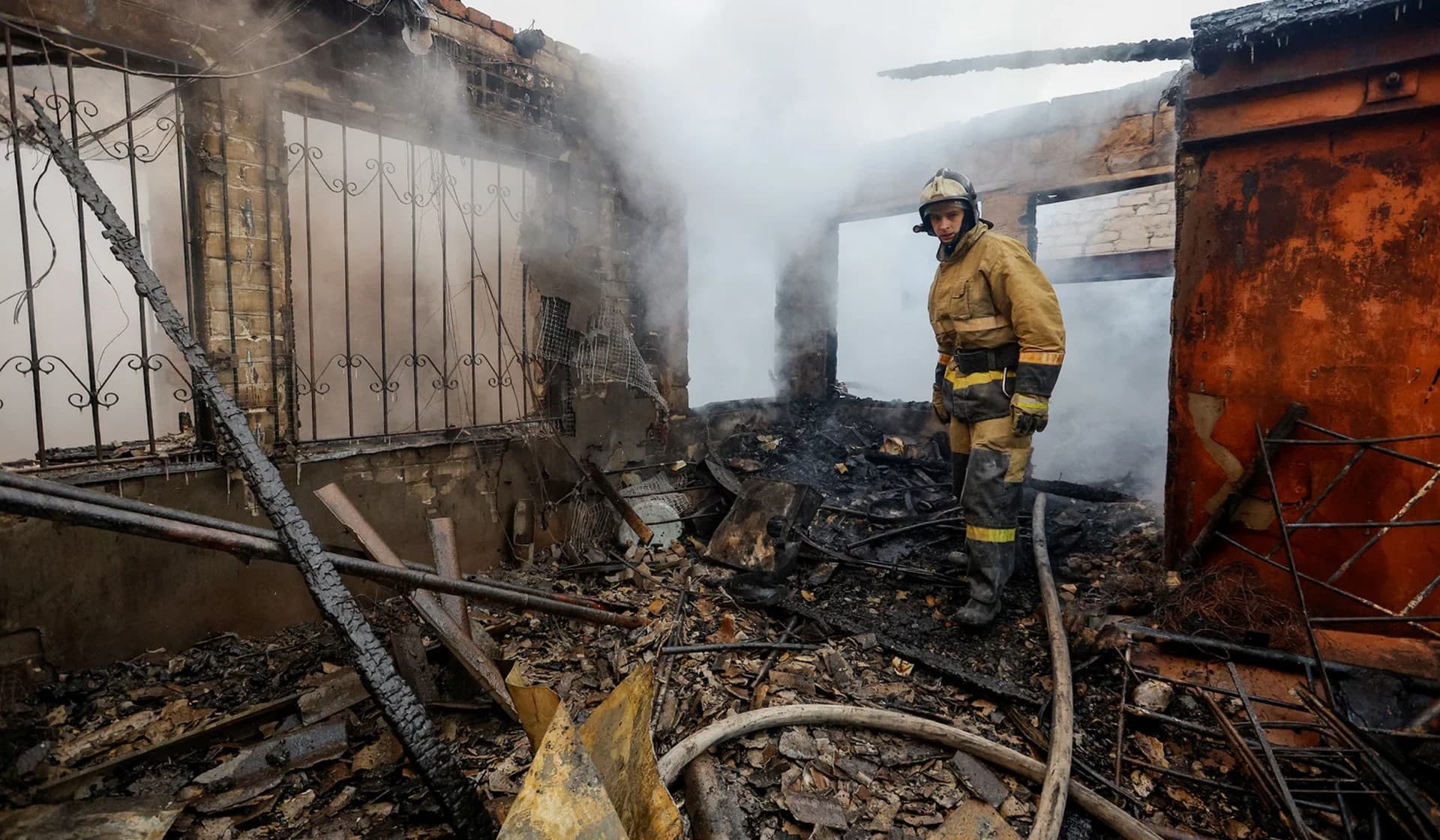 A firefighter works inside an office building heavily damaged in shelling in Donetsk