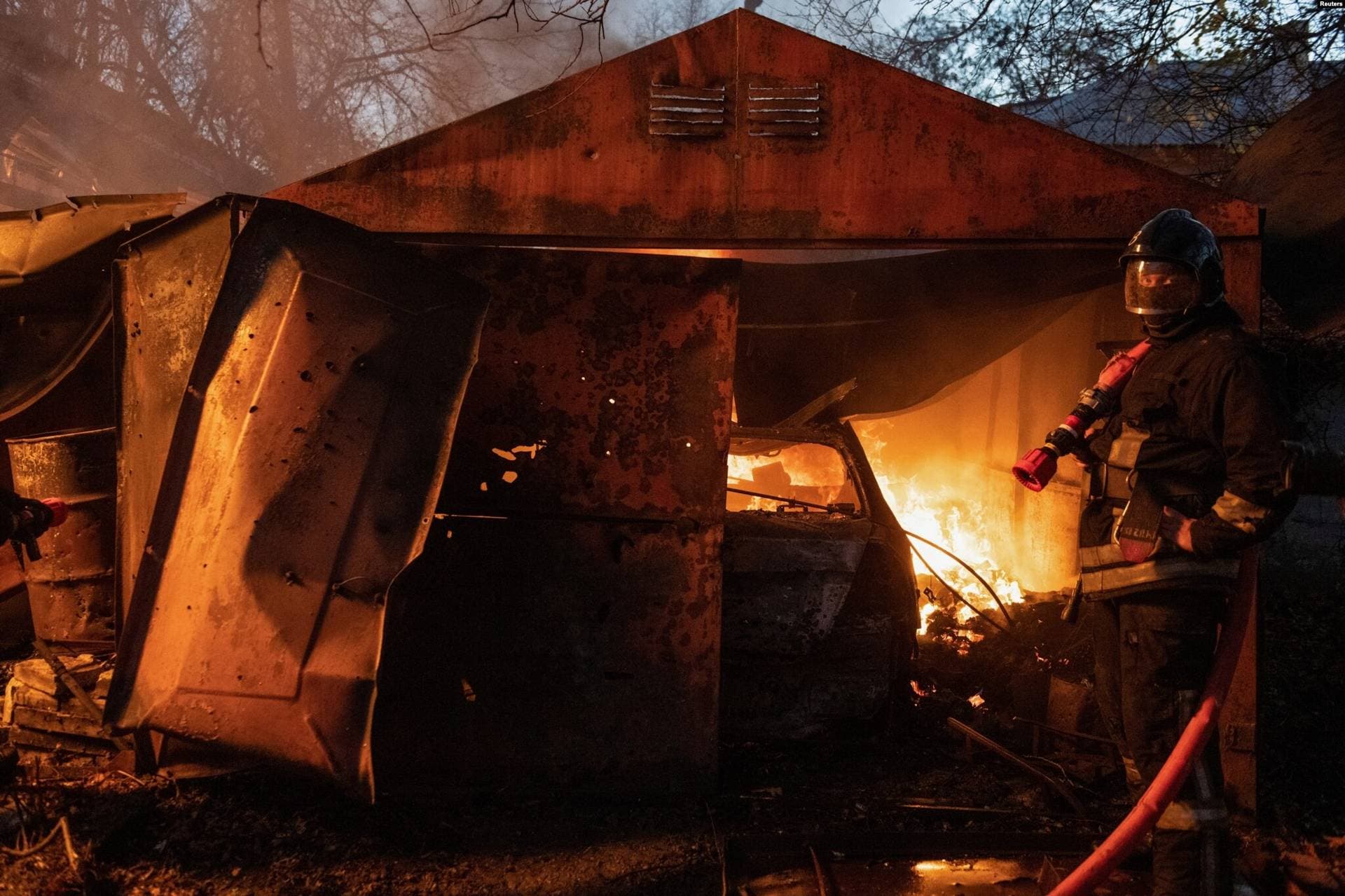 Rescue workers put out a fire in a garage