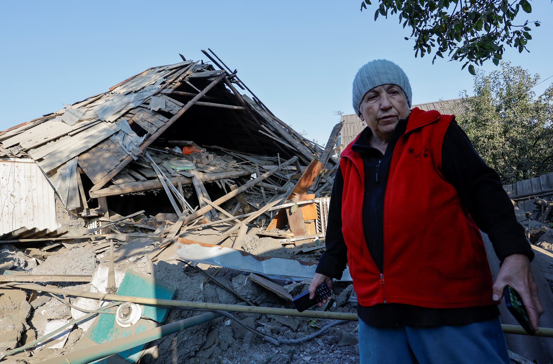 Local resident stands near a house destroyed by recent shelling in Donetsk