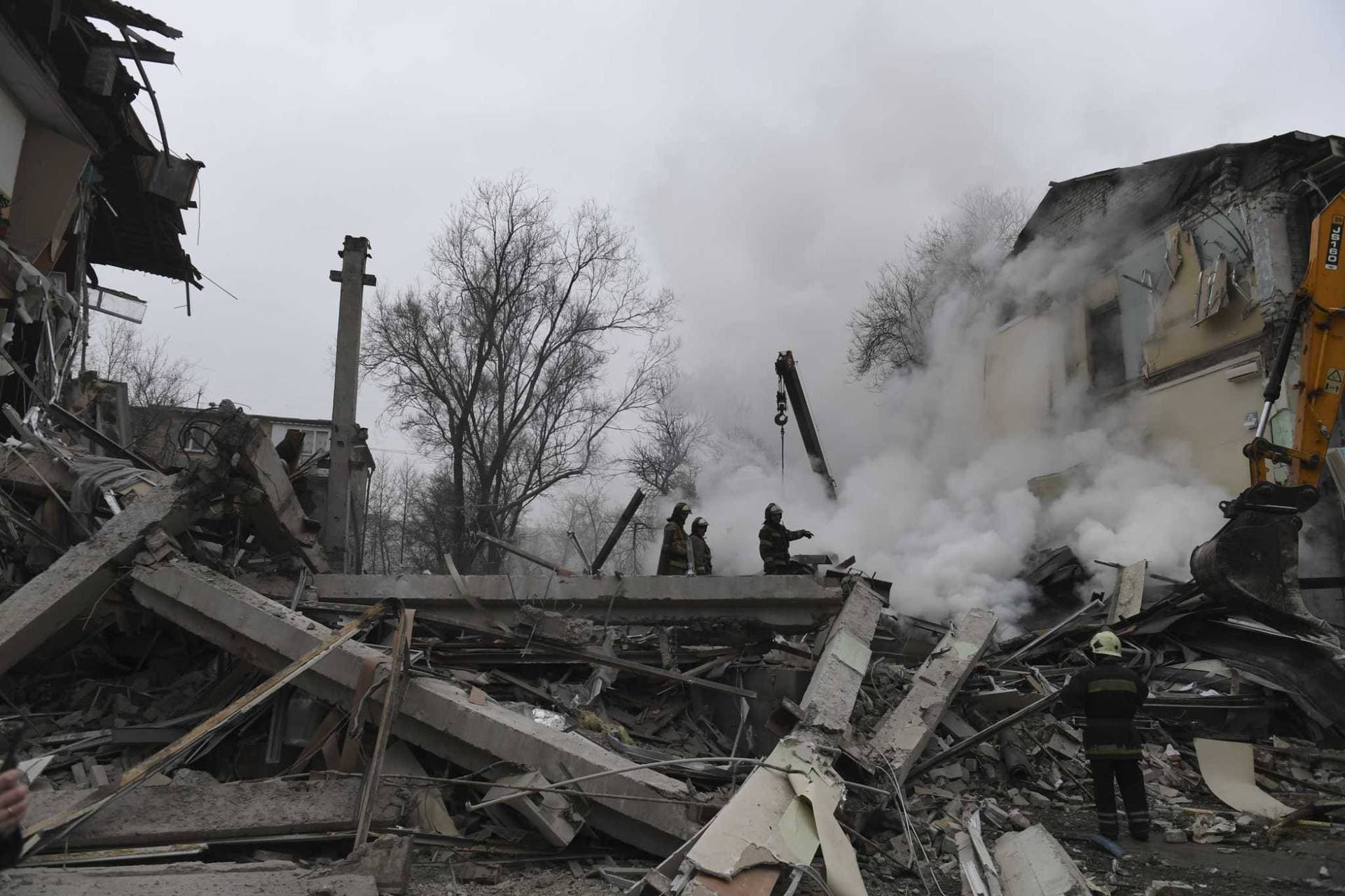 Smoke rises as Donetsk's emergency employees work at a site of a destroyed shopping center in Donetsk