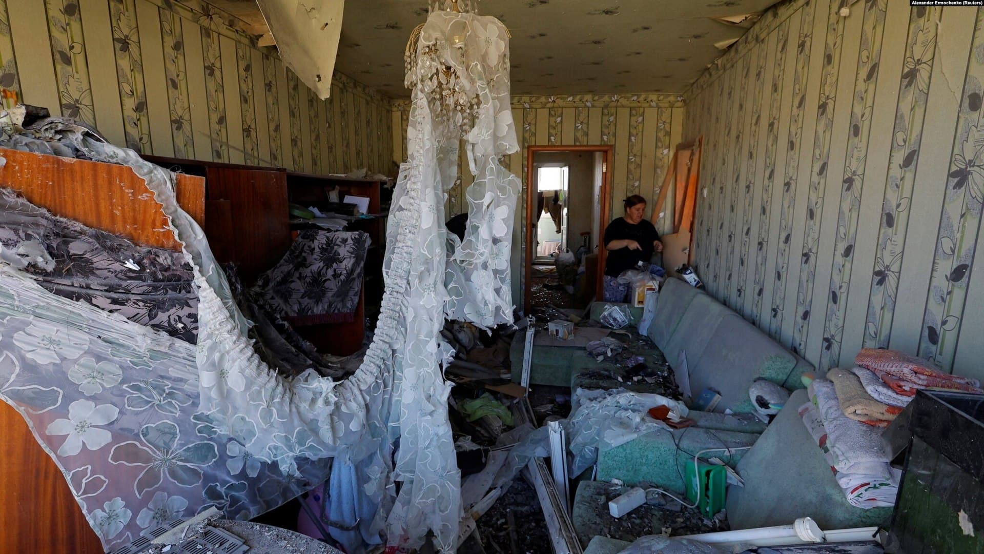 Local resident stands in apartment damaged by recent shelling in the Donetsk region