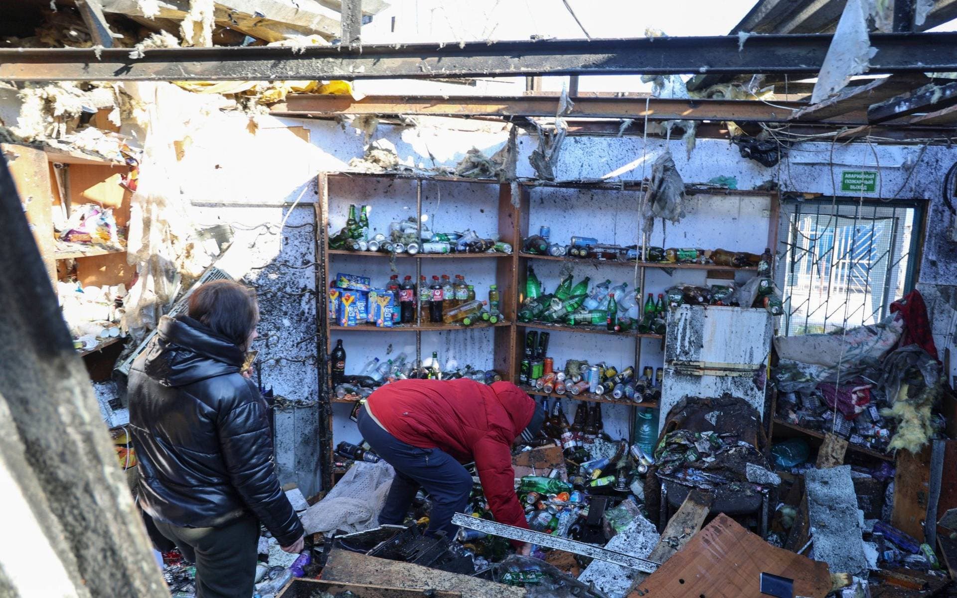 Locals at the scene following the shelling of the food market in Donetsk