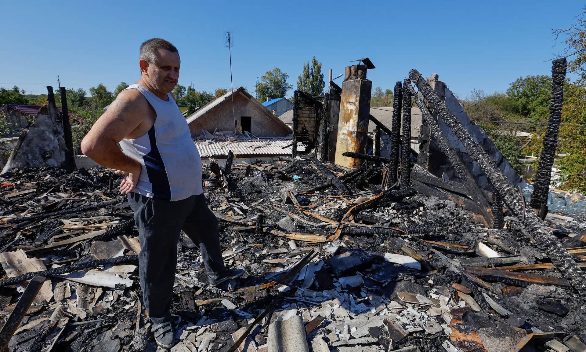 Local resident shows his house destroyed by recent shelling in Donetsk