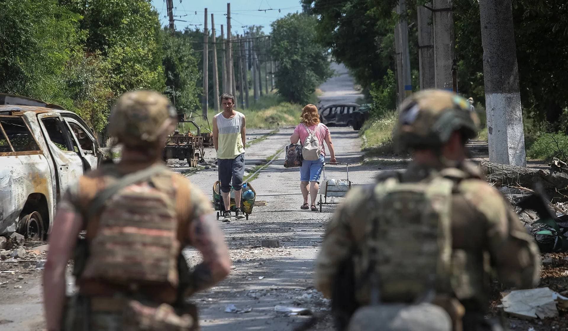 Members of the White Angels police evacuation unit take part in the evacuation mission from the frontline town of Druzhkivka