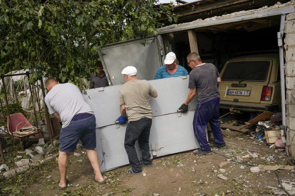Residents recover belongings from their homes after a strike in Druzhkivka