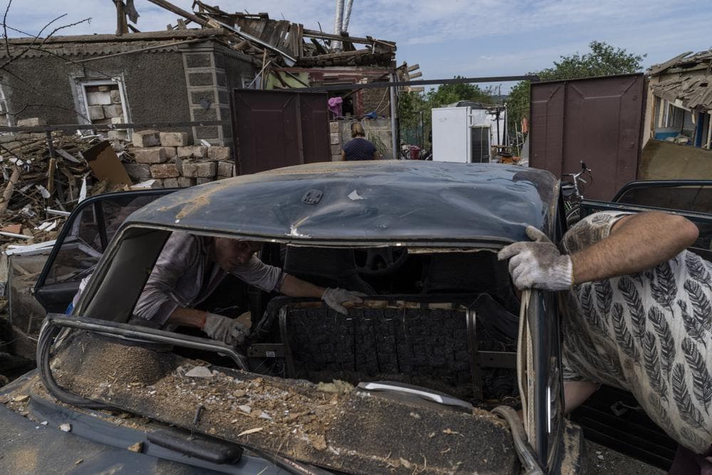 Residents inspect damages after a missile strike in Druzhkivka